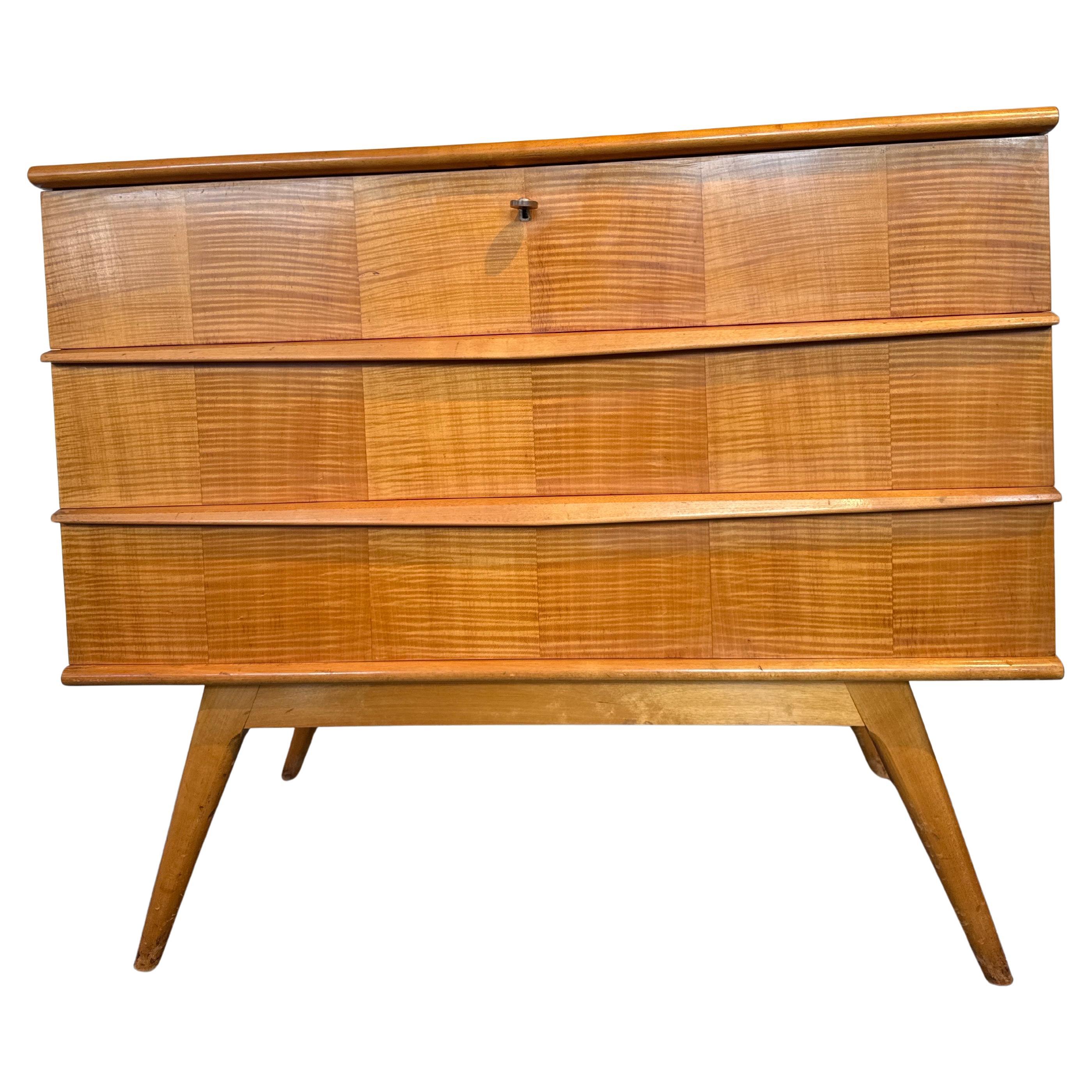 A very elegant in solid cherry wood and veneer three drawers chest designed by the Belgian designer Alfred Hendrickx for Belform in the 50's. In original good condition. The three drawers have a beautiful organic design in cherry wood finished