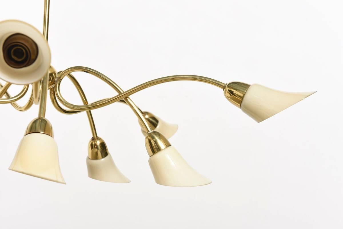 

Exquisite brass with white, crème opal glass shades. 
The lamp was designed in the Italian Stilnovo style. 
This style has became popular in Germany during the 1950s.

The elaborated workmanship and the fancy design with elegant rolling lines