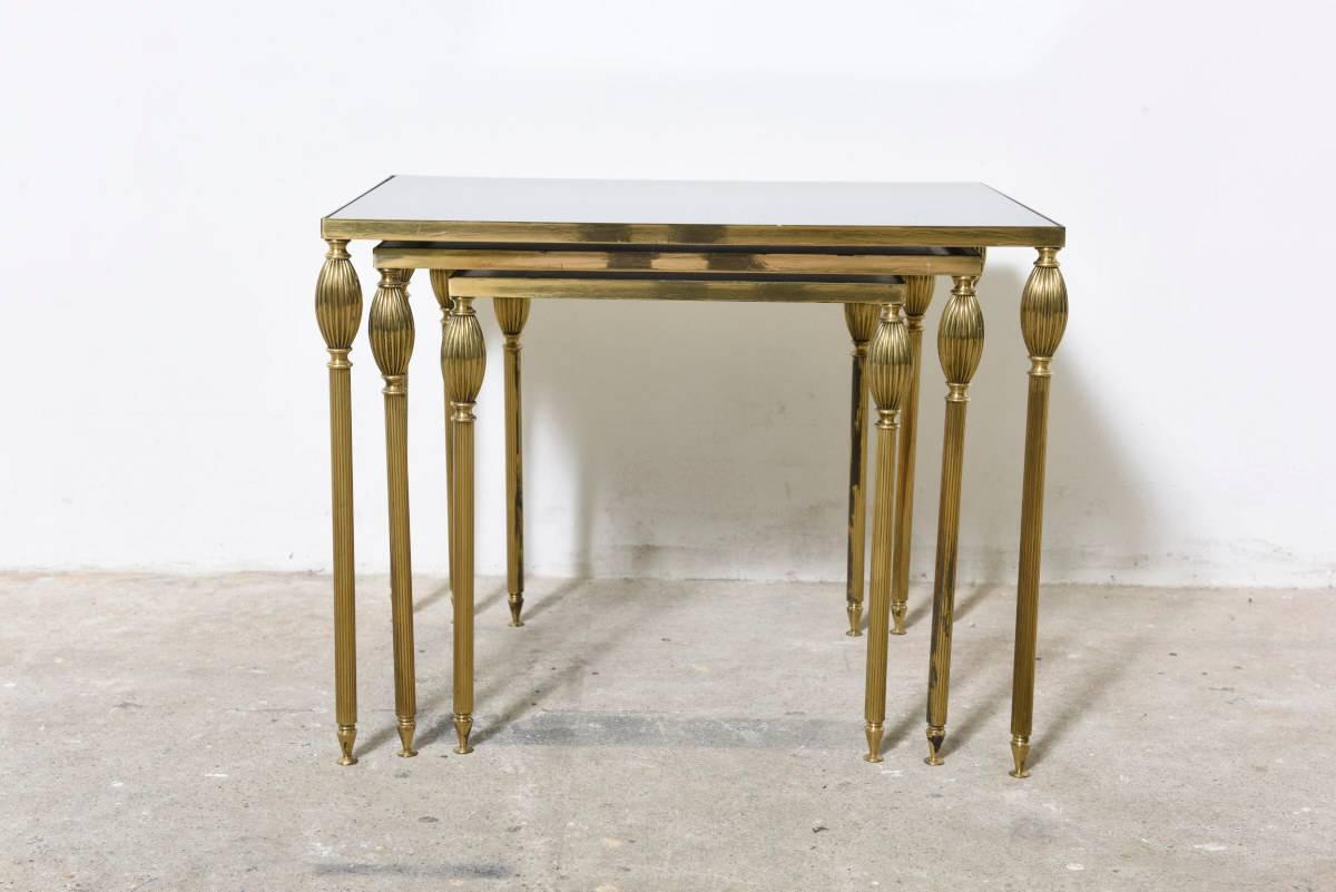 Low set of nesting tables made in brass and mirrored glass in the manner of Maison Jansen.