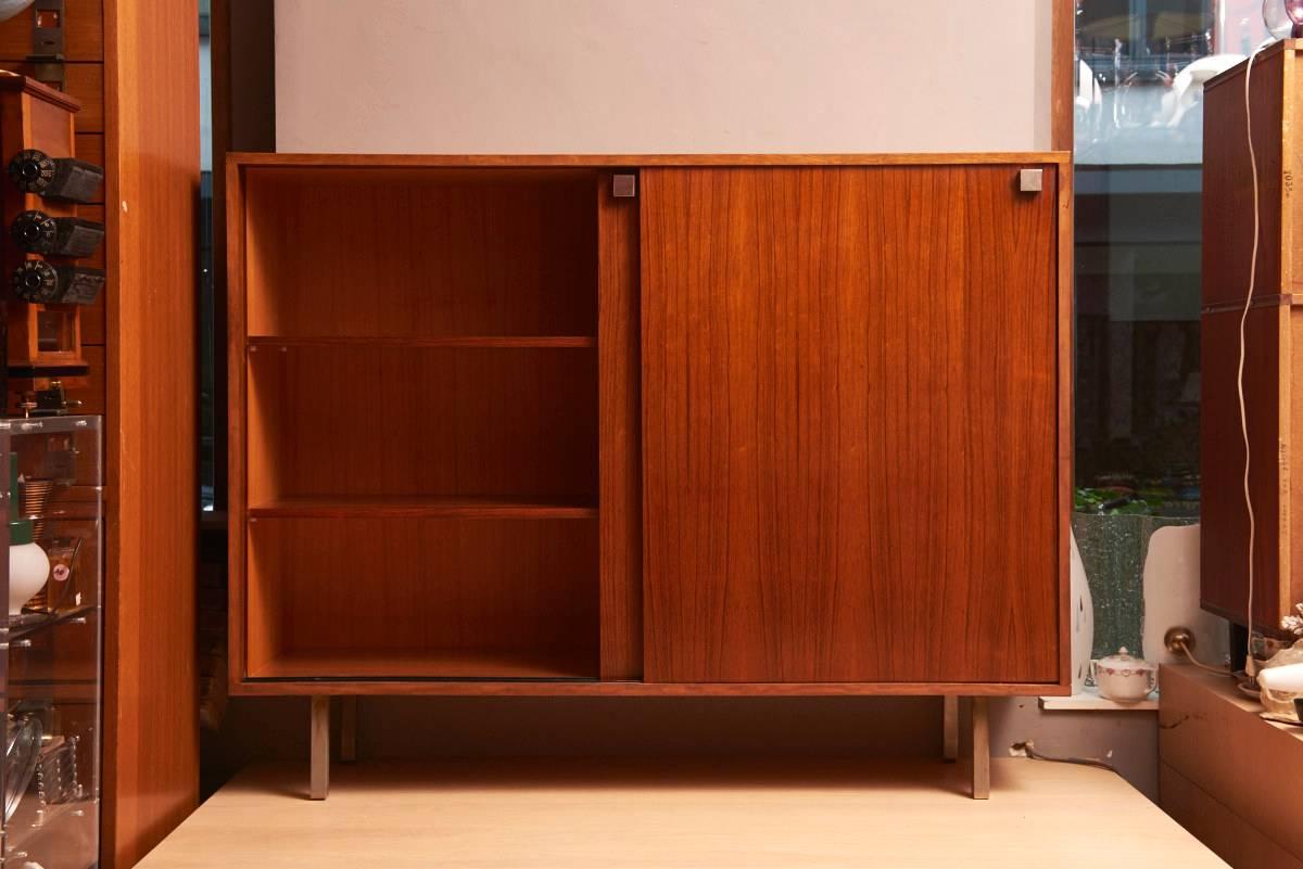 A 1960s Alfred Hendrickx Minimalist high sideboard. 
Two sliding doors with metal square handles. 
Inside three shelves and a compartment with four drawers and one shelve. 
In excellent condition.
   