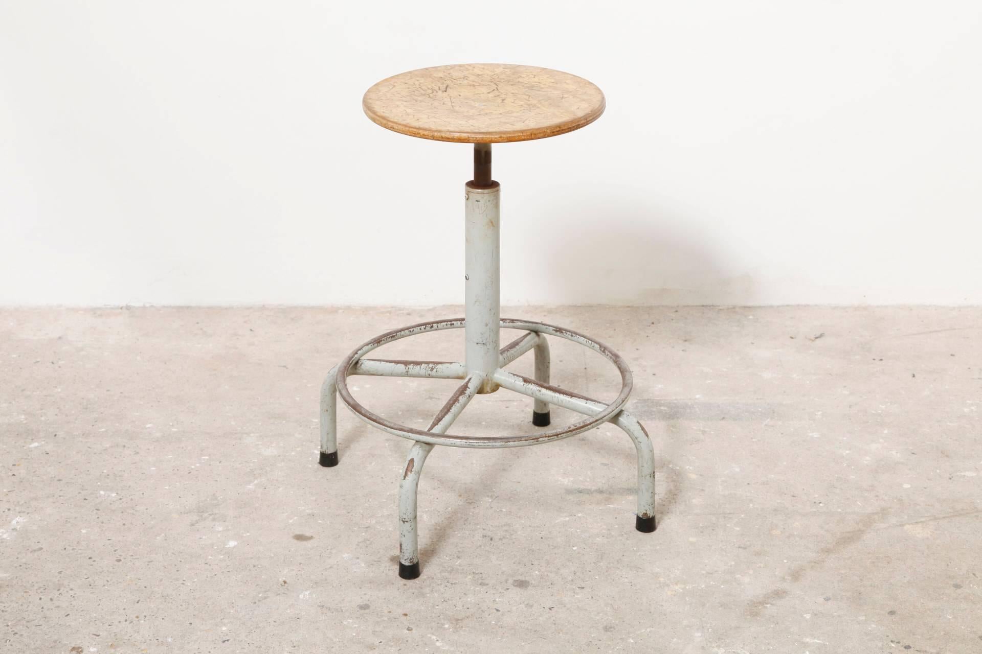 Beautiful rare set of six enameled metal tube and beech seat drafting stools. 

Adjustable height, foot rests and pedestal base with wide spread feet.
All good original condition with visible signs of wear and enamel loss.
Just very beautiful in