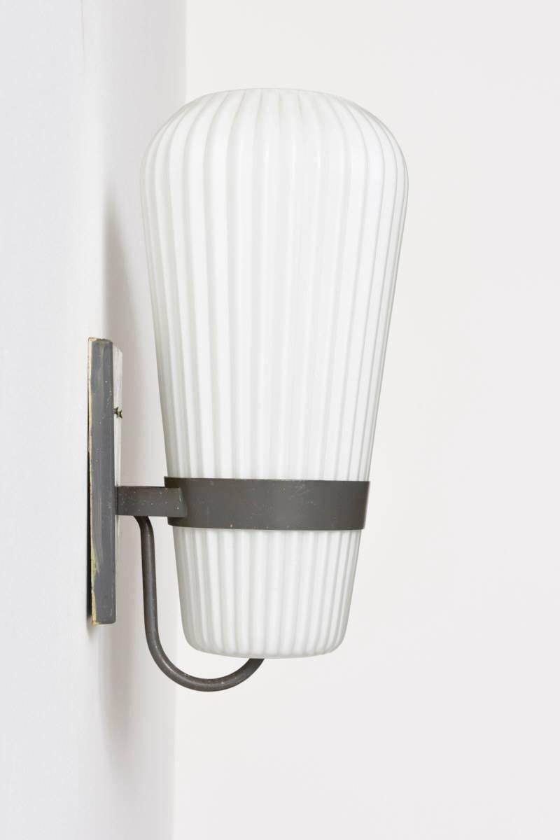 Very nice sconces designed by L.Kalff for Philips, Holland, 1950s. 
These sconces have a very nice combination of materials, ribbed opal glass and grey lacquered metal, labeled by Philips. 

All lamps are in good original condition. 

Eight