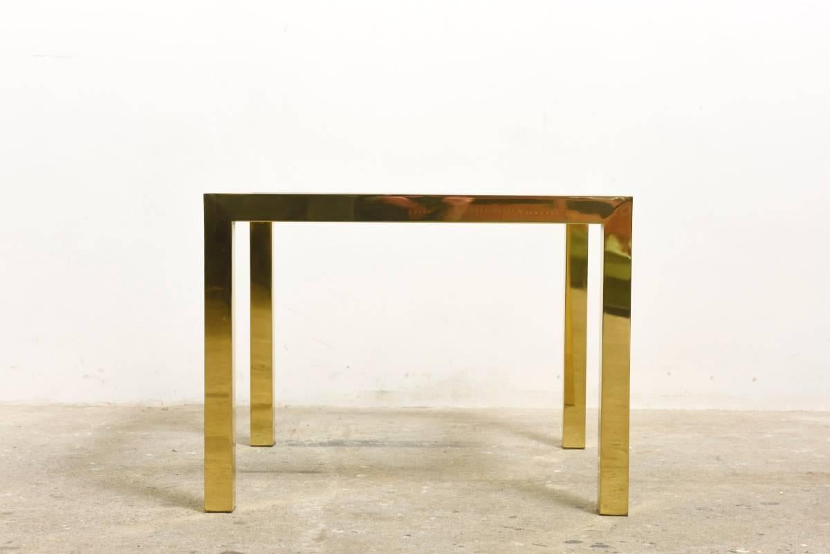 Beautiful and elegant side tables by Romeo Rega made of solid gilt brass, chromed metal and a clear glass top.