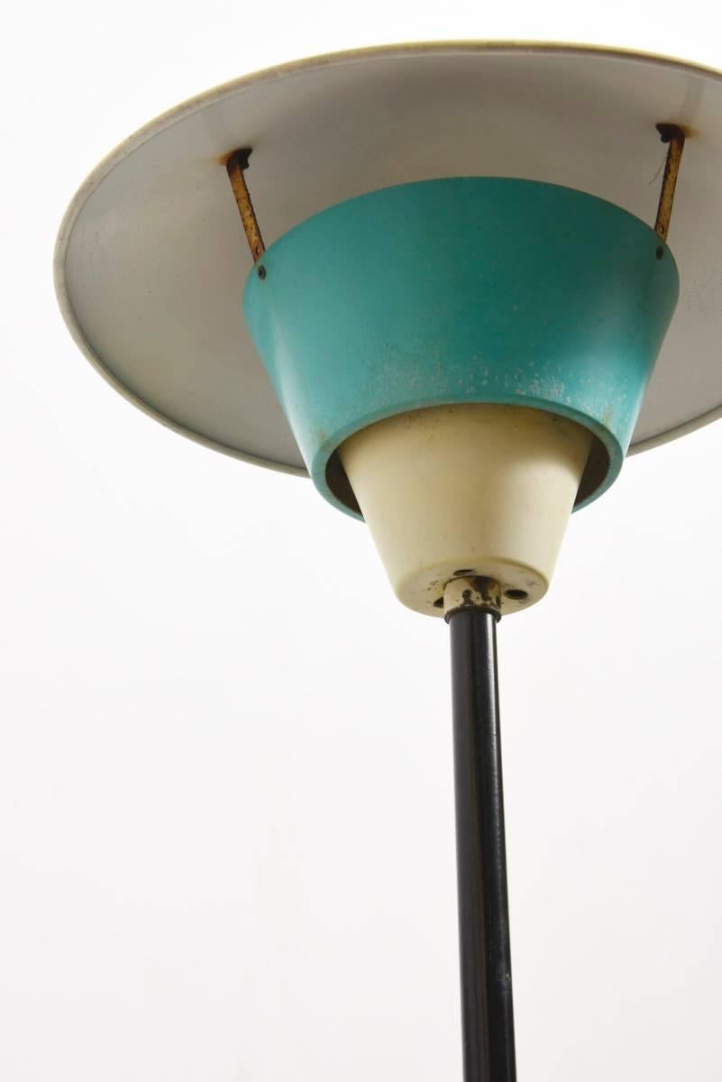 Beautiful floor lamp designed in the ambience of the 1950s with the colors soft yellow, green and red in its original condition with traces of use.