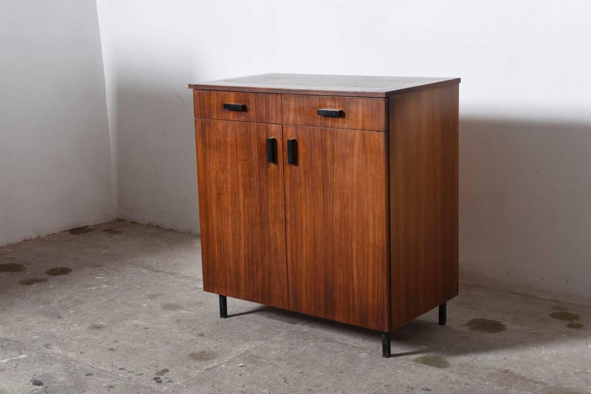 
Minimalist sideboard designed by Cees Braakman for Pastoe, the Netherlands, 1958.

The sideboard has an outstanding clean geometrical design with a minimal black lacquered metal base, beautiful teakwood and black rectangular handles. The