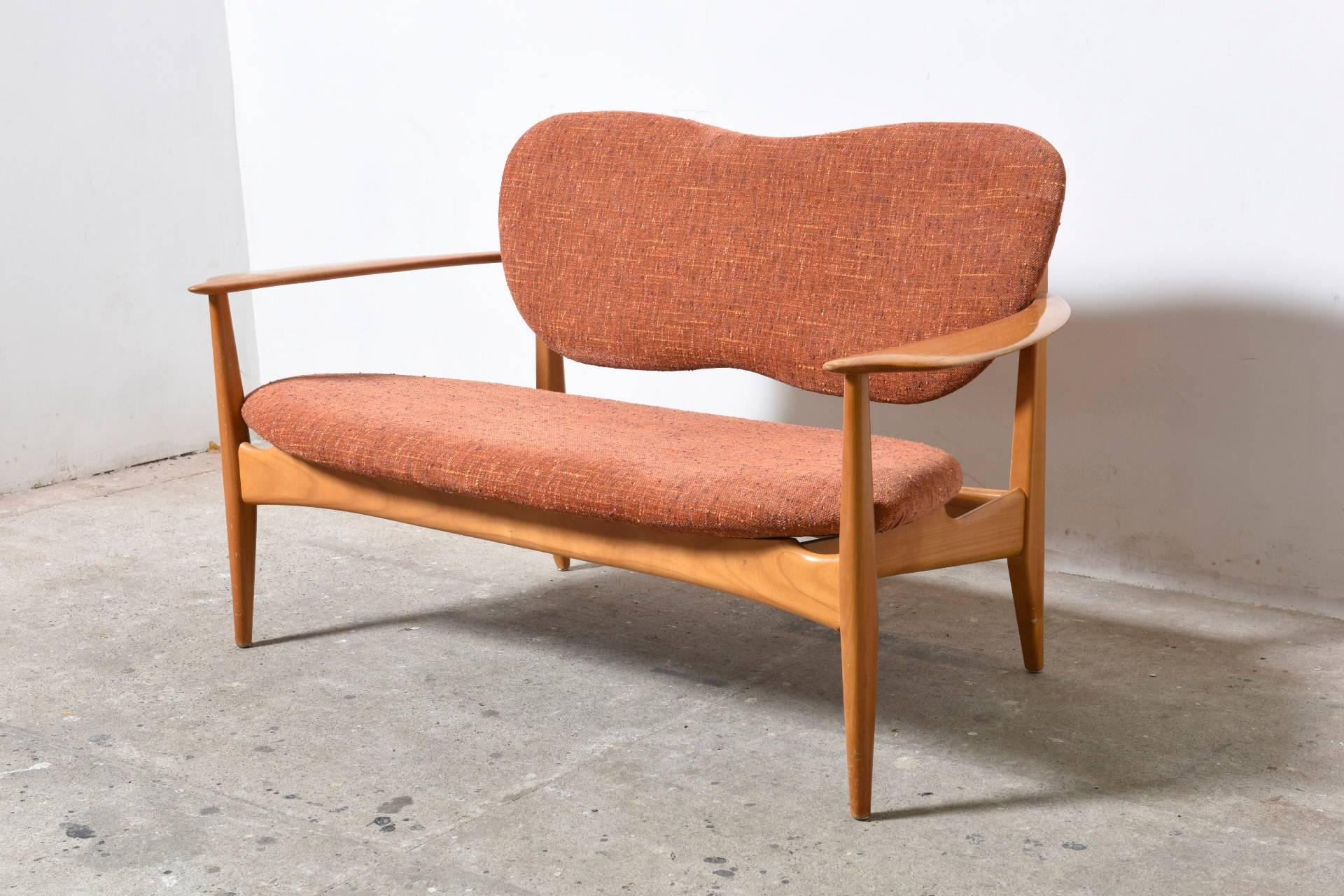 This rare sofa was designed during the 1950s
It features a frame made from a nice warm cherrywood and upholstered with a soft original fabric.

Be sure to check out the matching loveseat and two easy chairs we have in stock.