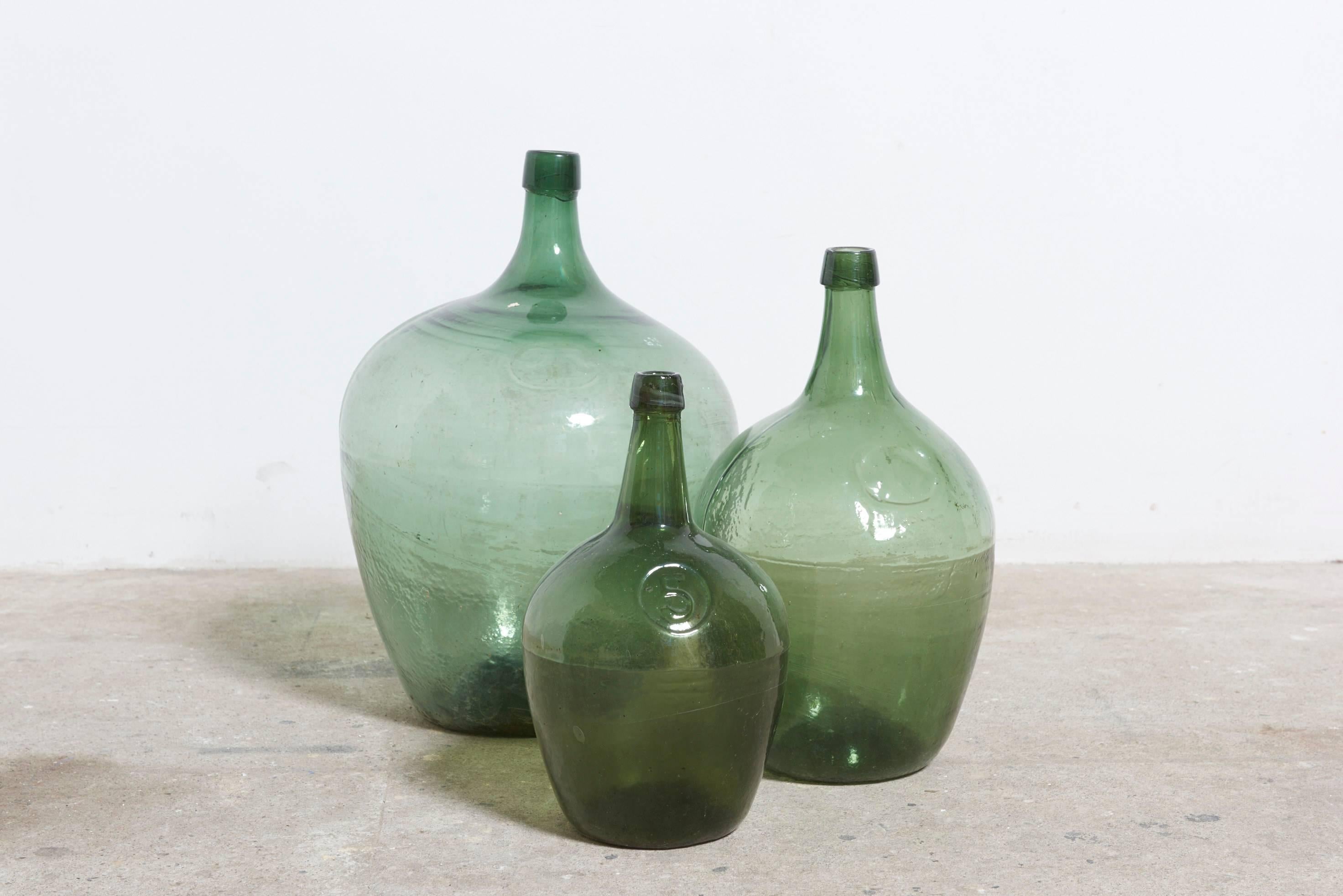 Free-blown bottles 5.L   .10.L.   20.L.  with rough pontils and applied lips manufactured in Mecklenburg, 19th C.Germany.
Demijohn is an old word that formerly referred to any glass jars, bulk bottles with a large body and small neck.
The word comes