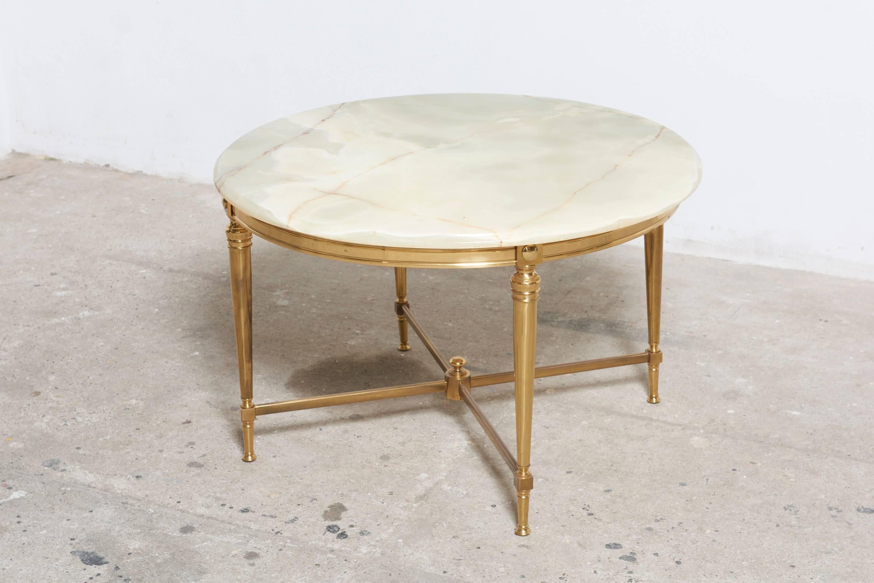 Onyx marble is pure luxury in stone, supported with an elegant bronze base.

The round onyx marble tabletop is an extravagant and luxurious statement piece a highlighting in every modern living room.