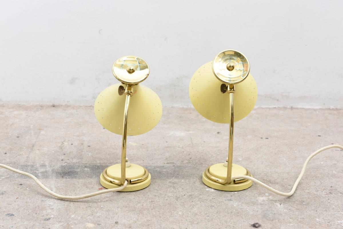 Very nice 1950s design of two desk lamps or bed night lamps.
The shades are adjustable, the lighting gives a nice shine through the perforated holes.
Good condition.