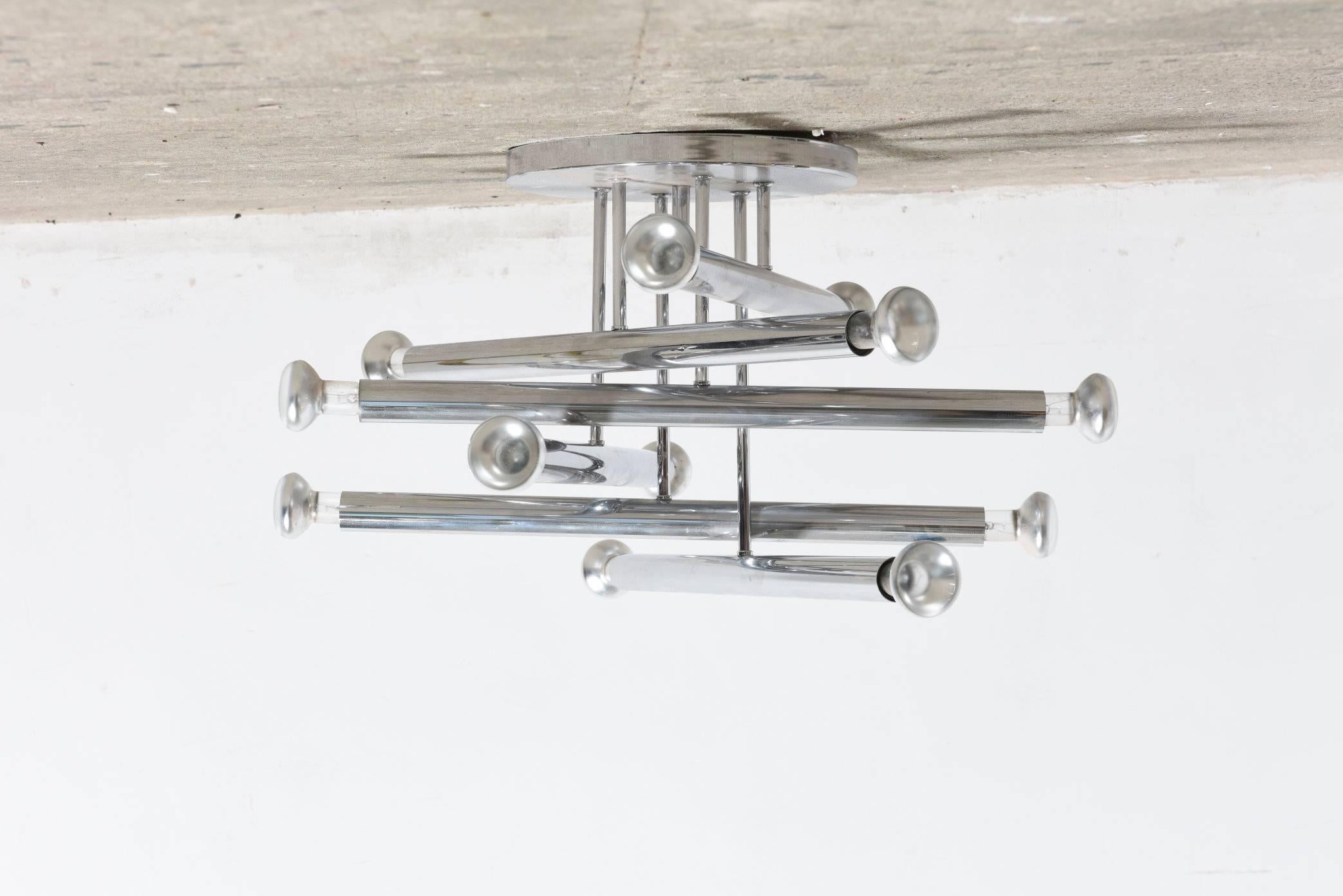 A 12 light flush mount modernist ceiling light in chrome composed of multiple chrome tube by Geatano Sciolari.
 

Designed by Sciolari for Belgian Manufacturers Boulanger

This twelve-light fixture creates a powerful statement casting diffused