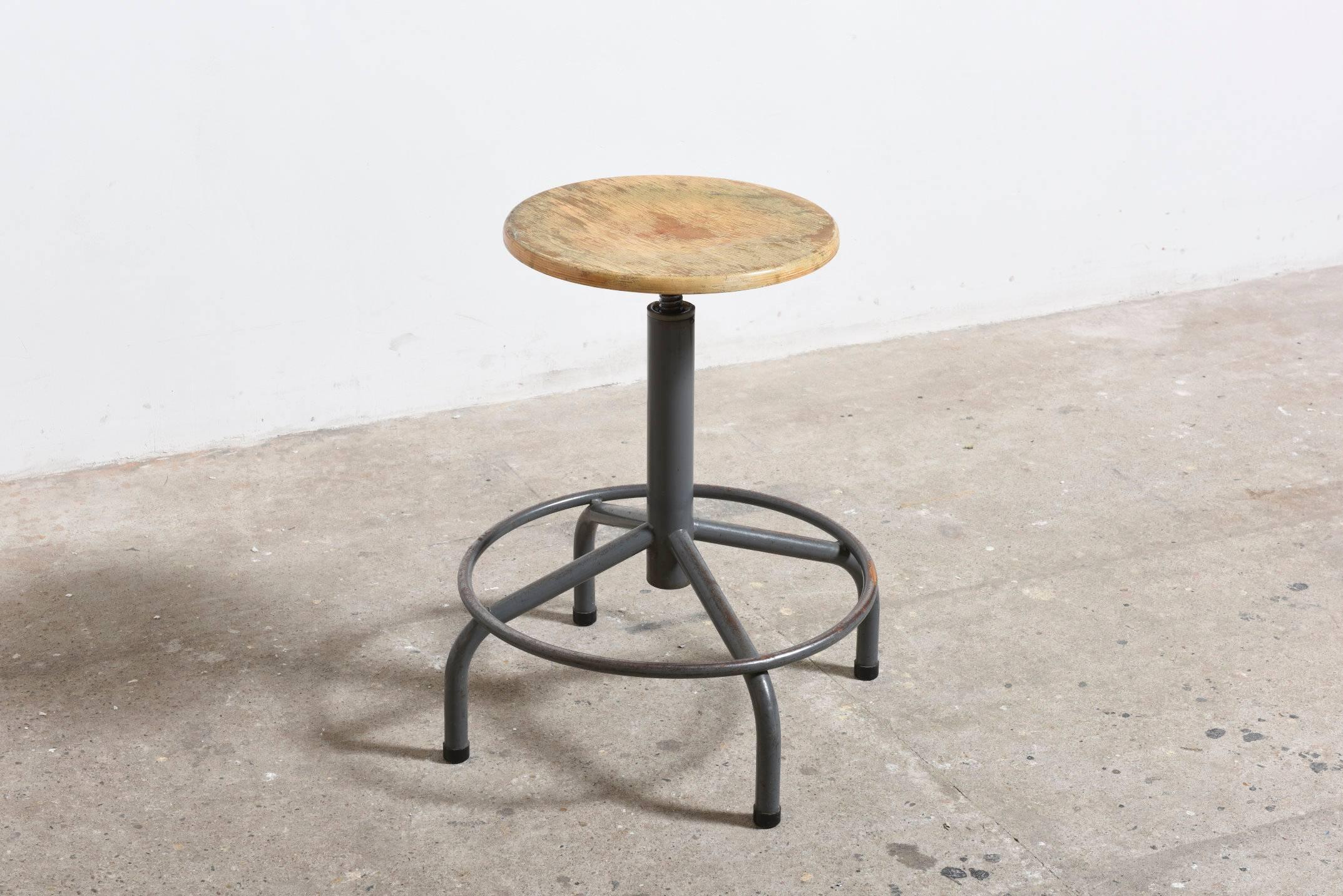 Beautiful rare set of six enameled metal tube and beech seat drafting stools. Adjustable height, foot rests and pedestal base with wide spread feet.
All good original condition with visible signs of wear and enamel loss. 

Just very beautiful in