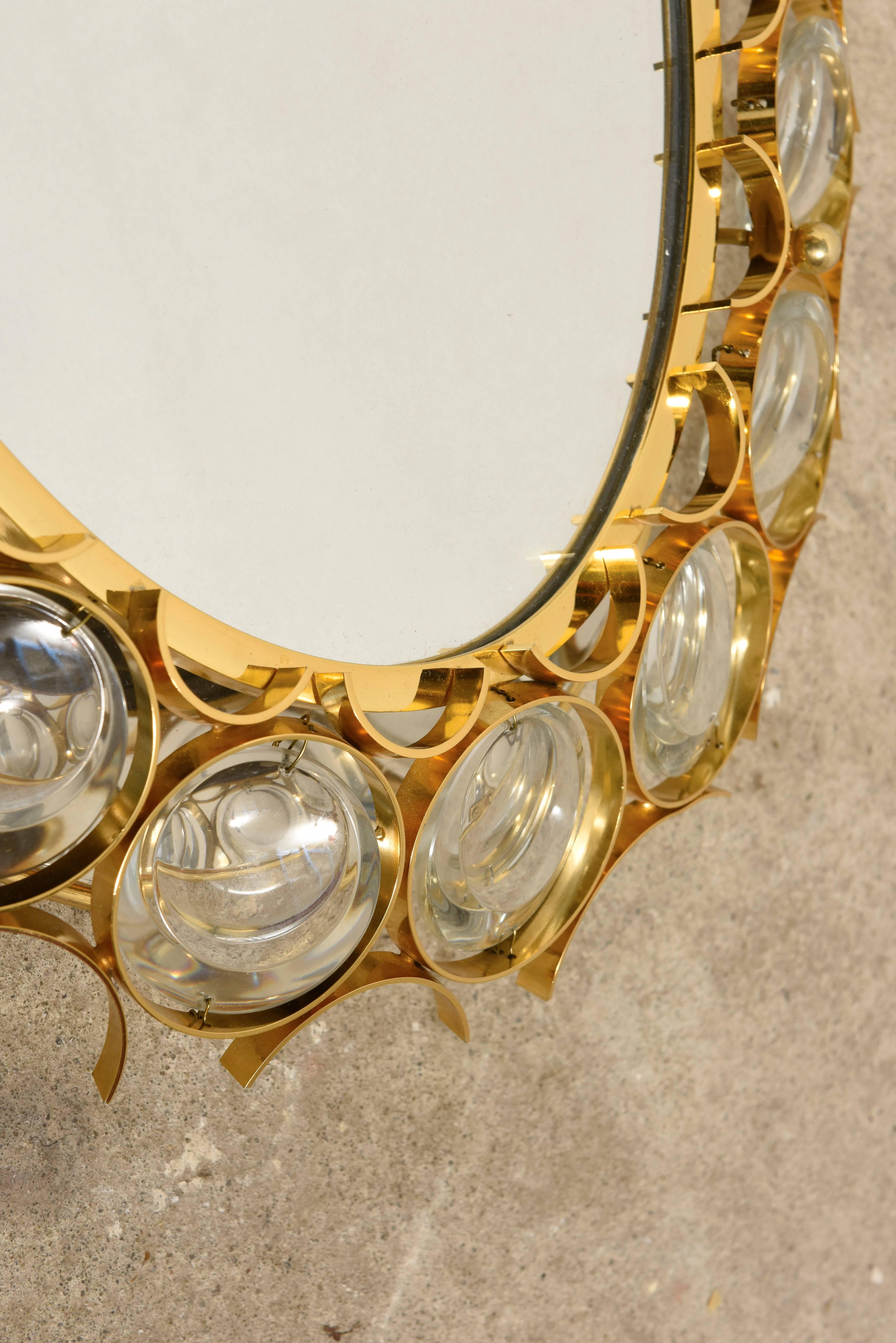 This vintage backlit oval glass mirror featuring a gold-plated brass frame with encircled glass crystals illuminated by eight light bulbs (40W each) designed during the 1960s by Ernst Palme by Palwa and produced in Germany. 

Very good condition.