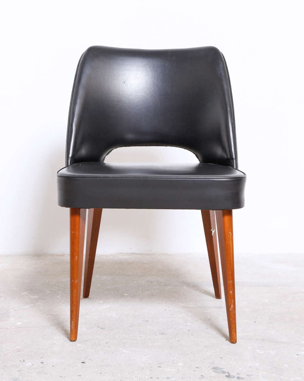 A set of four Mid-Century Modern organic form 1960s chairs with black leatherette upholstered and wooden legs made by Thonet. 
Original good condition.