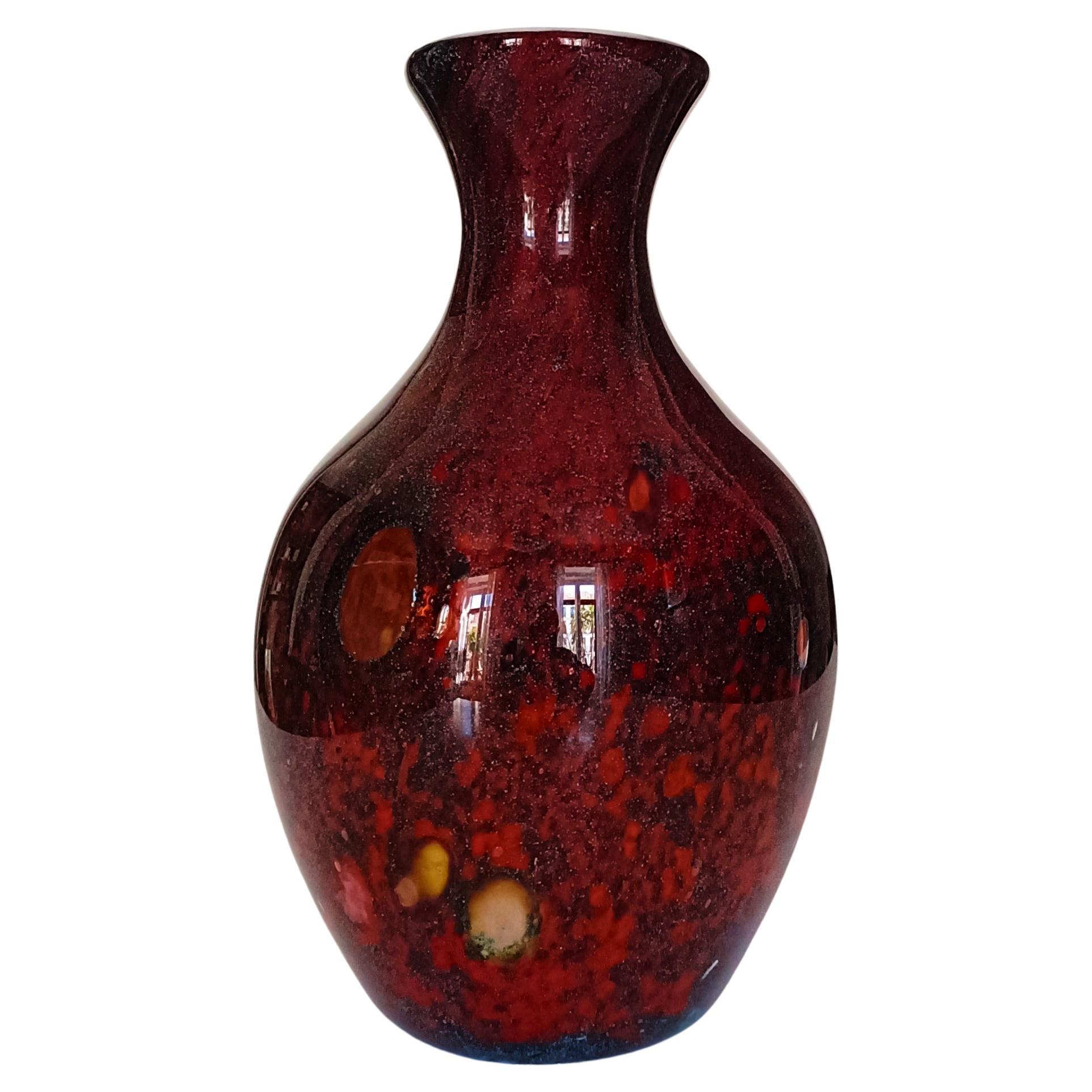Step into the timeless elegance of Mid-Century Modern Murano glass with this exquisite hand-blown vase, a gorgeous piece that blends artistry and craftsmanship. 

This outstandingly beautiful piece features an intricate pattern of red and burgundy
