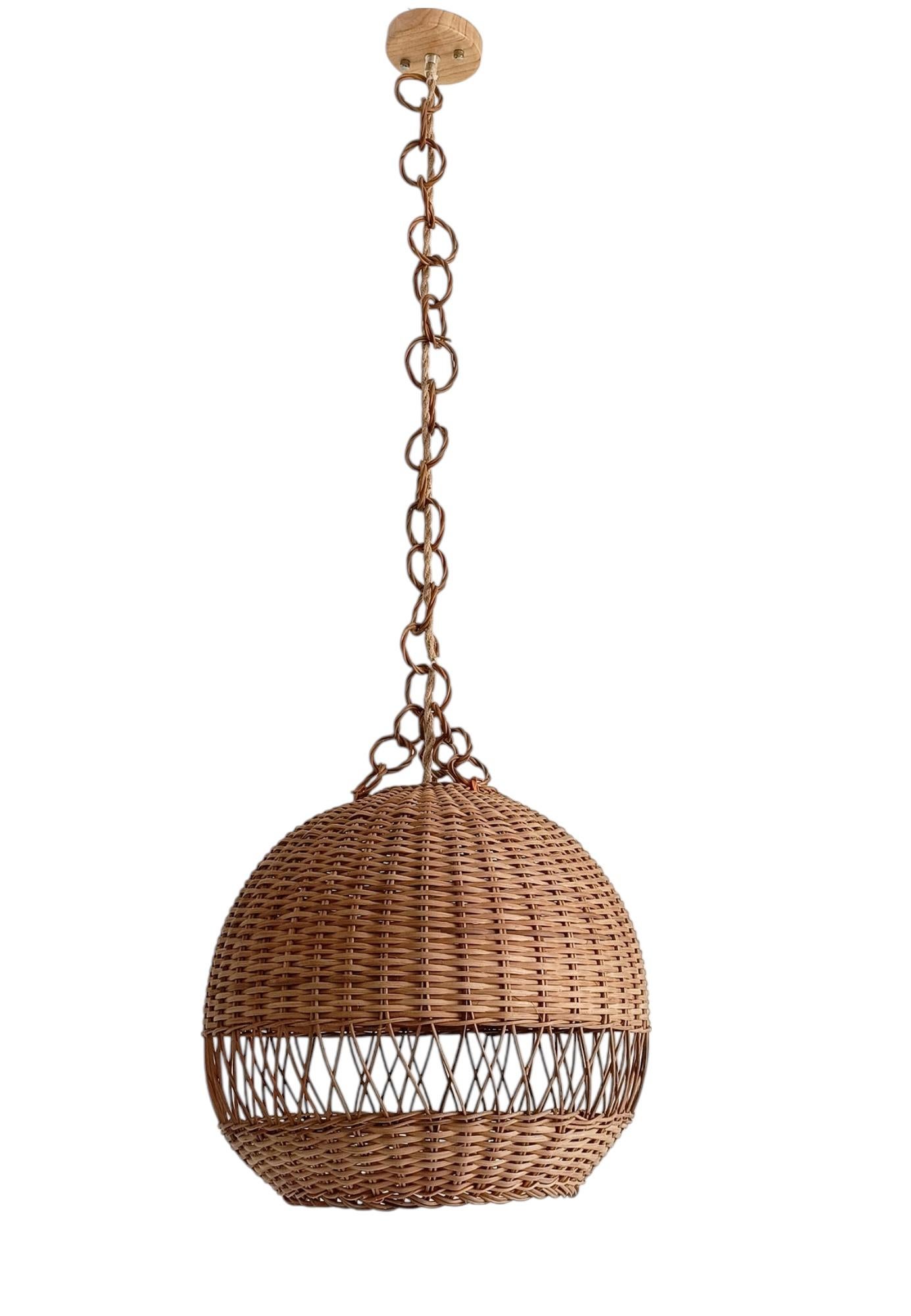 Vintage Rustic Midcentury Wicker Pendant Lamp, Spain, 1970s

A large balloon-shaped wicker pendant lamp, handcrafted in Spain circa 1970s. Reflecting the ease and character of French Riviera and Coastal style, it offers a warm, natural presence.

In