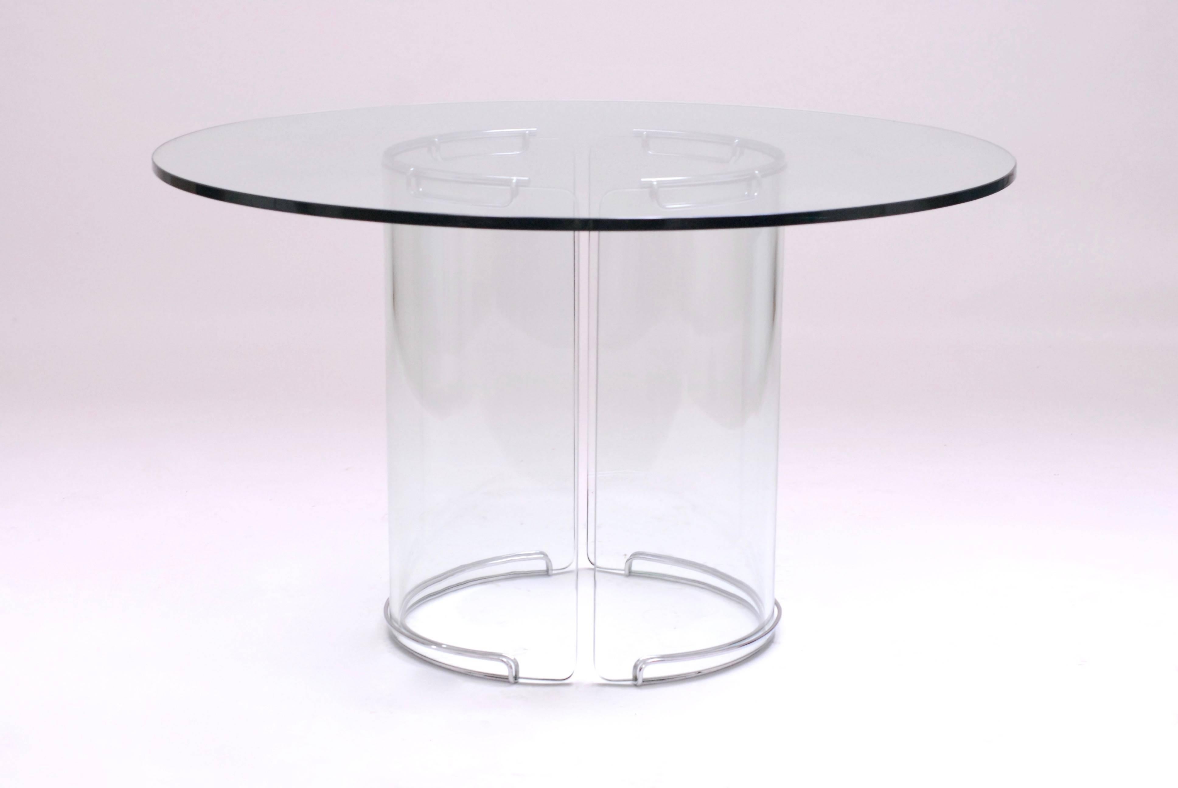 Remarkable dining table in glass and chrome. It was bought by the previous owners in 1978. 
It comes in three parts. Two glass parts forming the base and the glass top of 130cm diameter. The chrome parts are being placed at the top and floor for