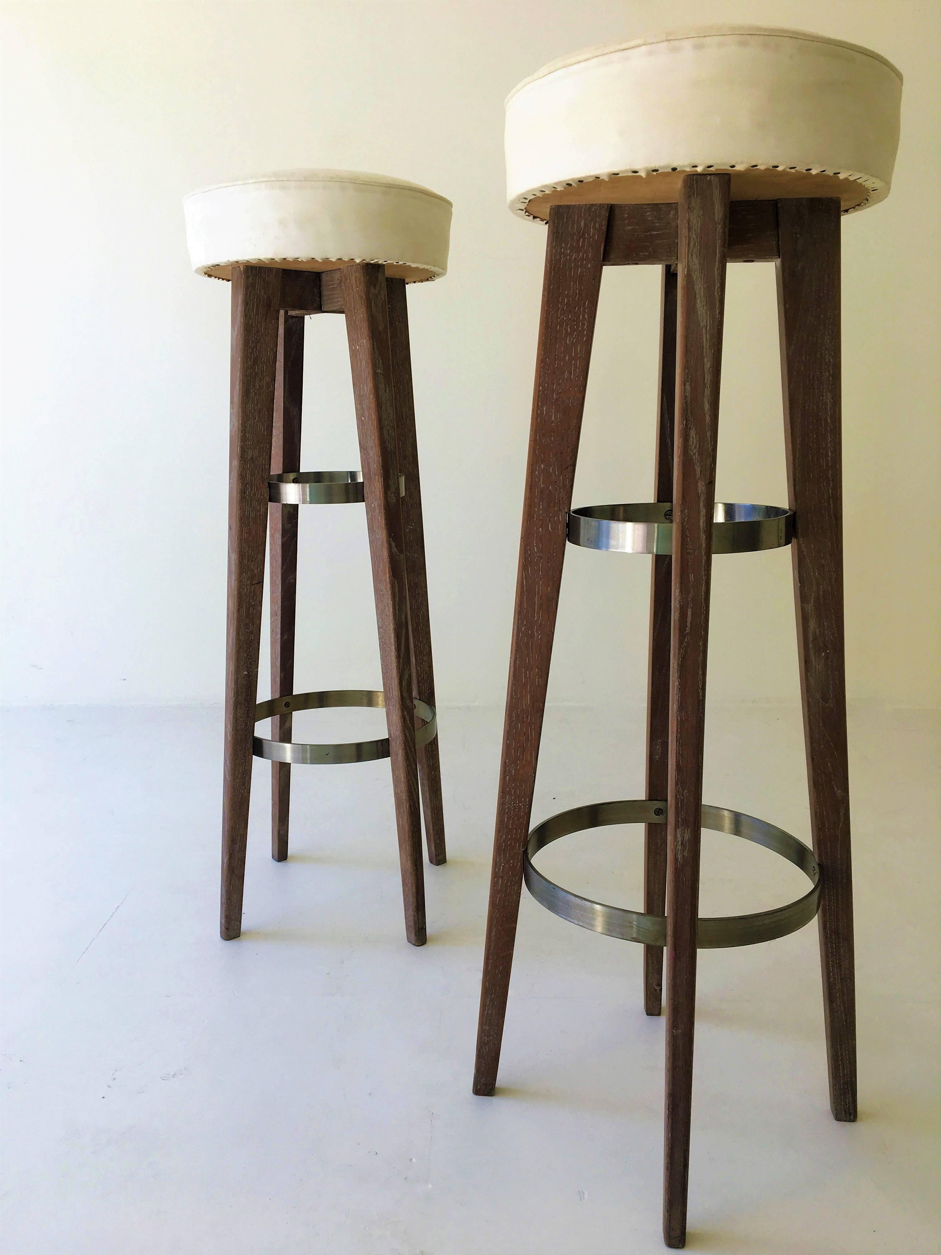 Pair of unique bar stools form the 1950s with their original vinyl cover. Very slim and high design.
