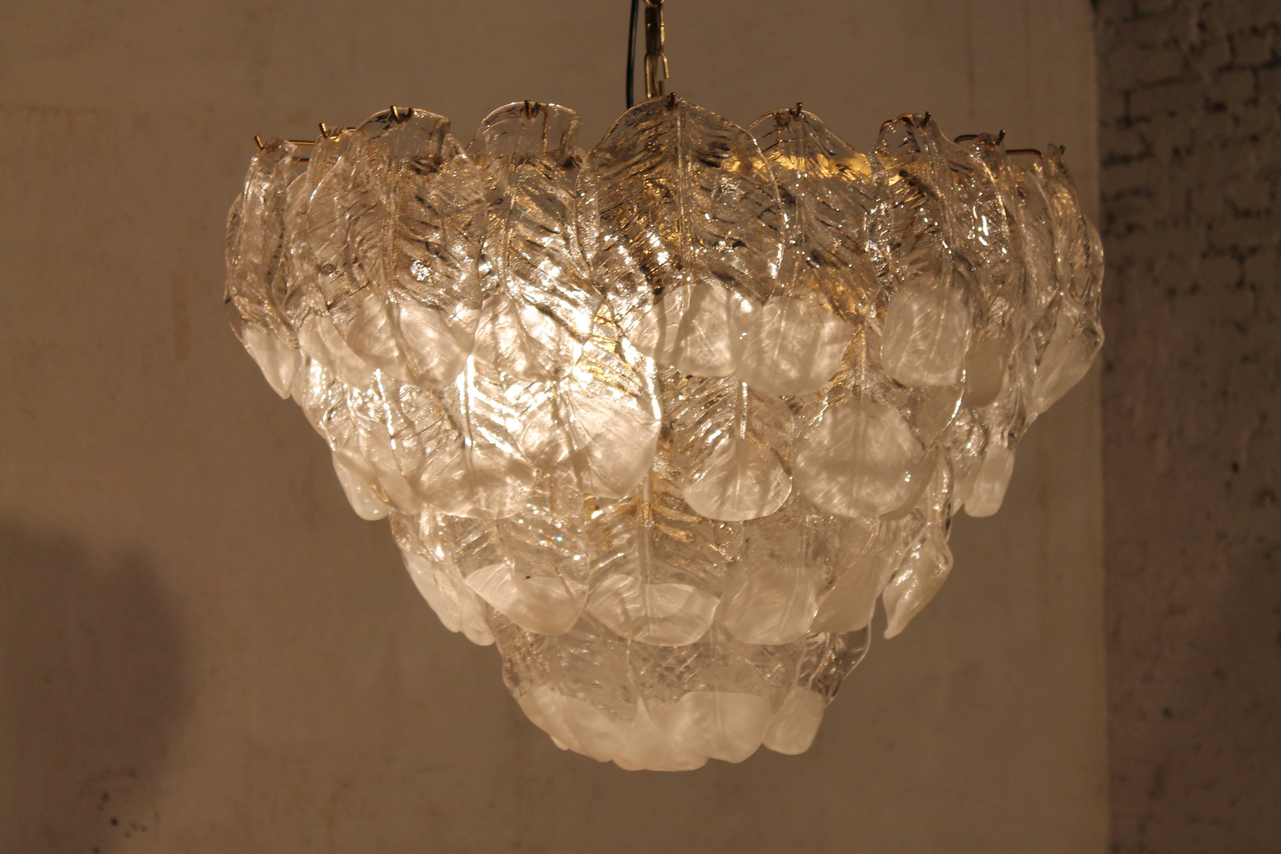 Large vintage Mazzega glass leaf chandelier, Italy, 1960s.

Very nice and big chandelier, with clear and white glass leafs

complete and good working condition also wired for US use

five big light bulbs each 75 watts

original vintage piece.