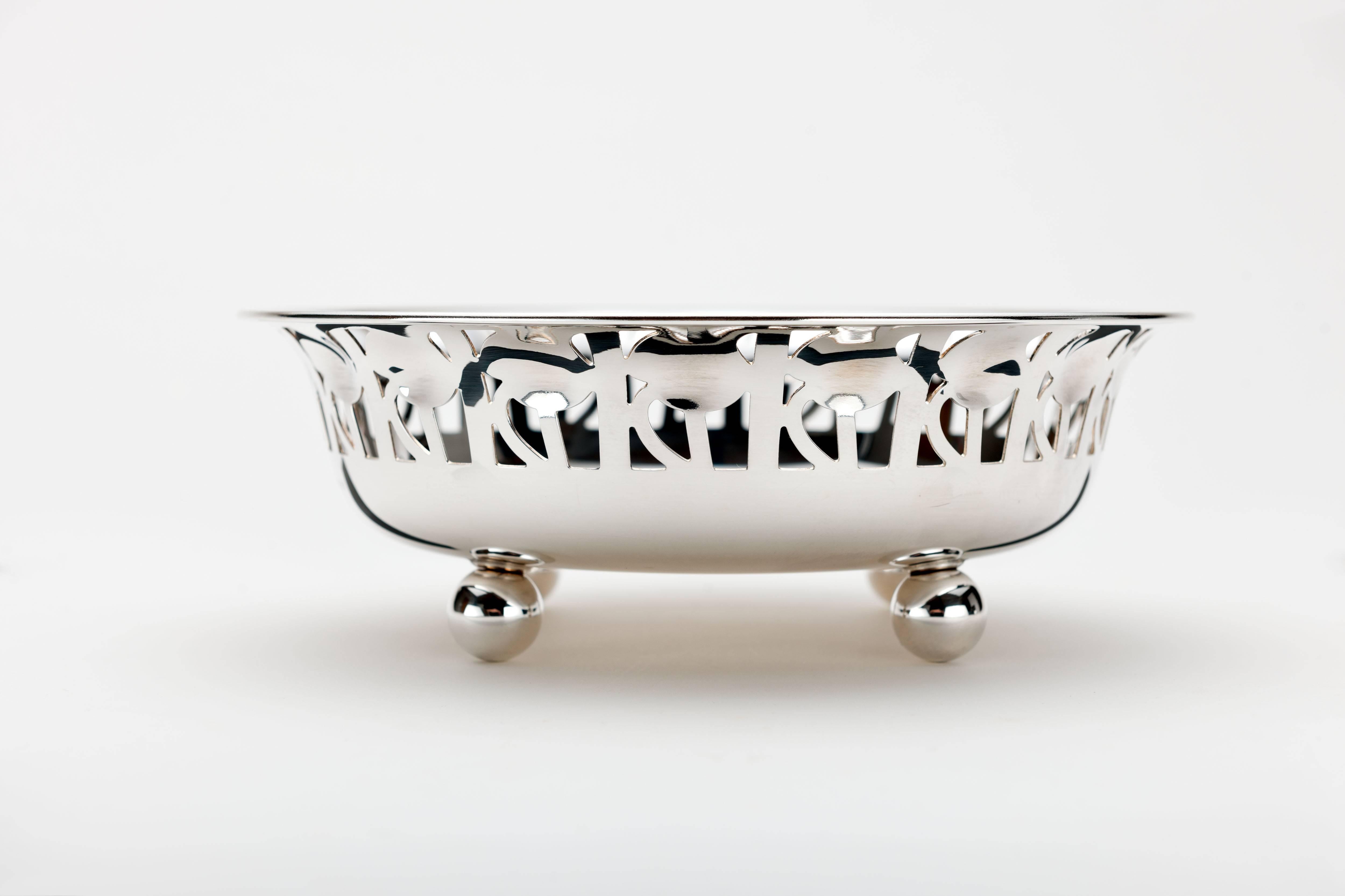 Vintage brass silver plated 'Rosenschale' rose bowl designed by Peter Arnell and Ted Pickford, made circa 1983 by Alessi. 
This rounded open bowl stands raised on four ball feet with a pierced rose leaf design repeated around the rim with impressed