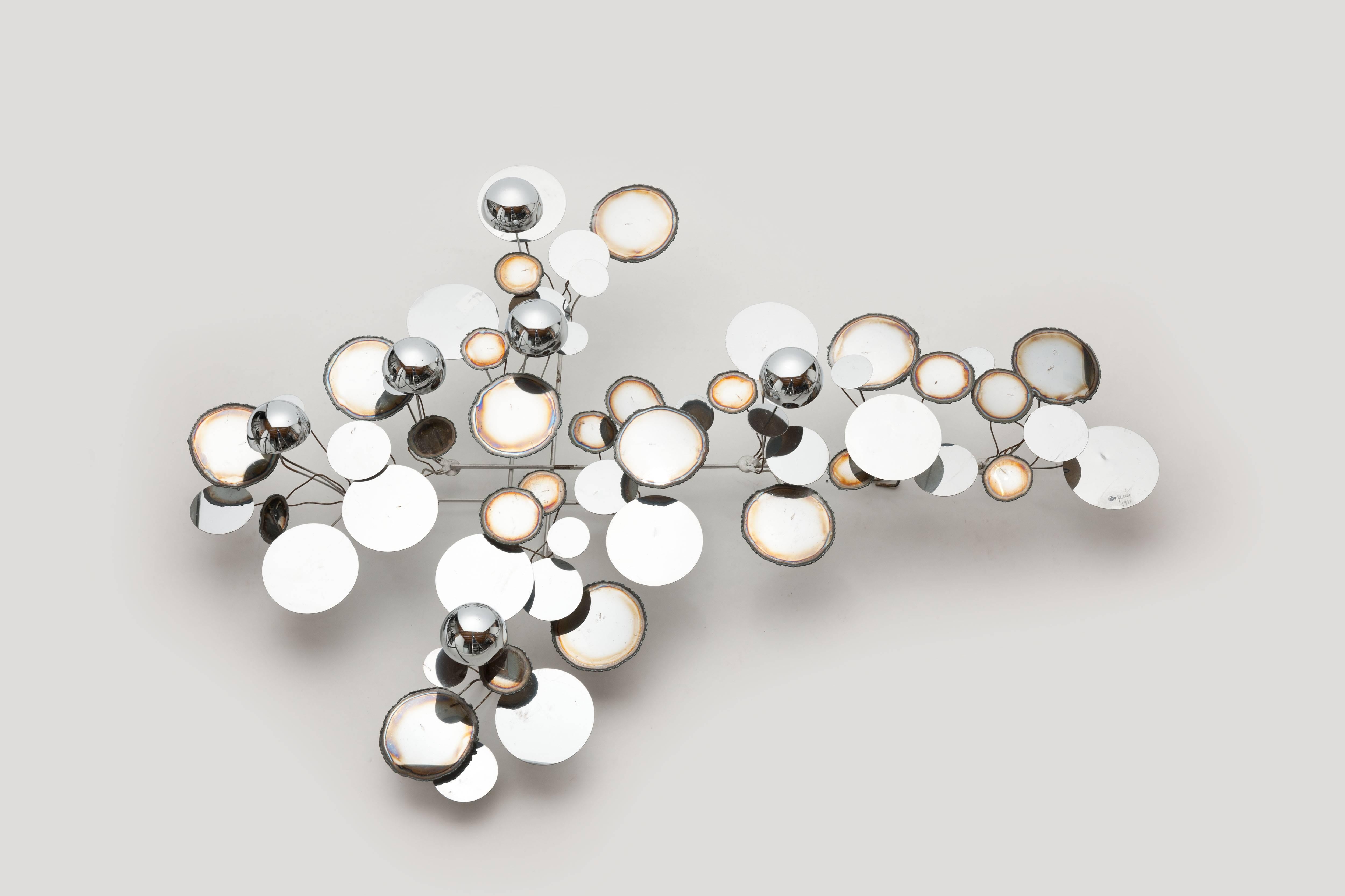 Beautiful vintage polished chrome "raindrops" wall sculpture by Curtis Jeré, by Artisan House. Handmade, 1971, signed with date. 
Wall sculpture is made of polished and burnished chromed metal disks and half-globes at varying depths.