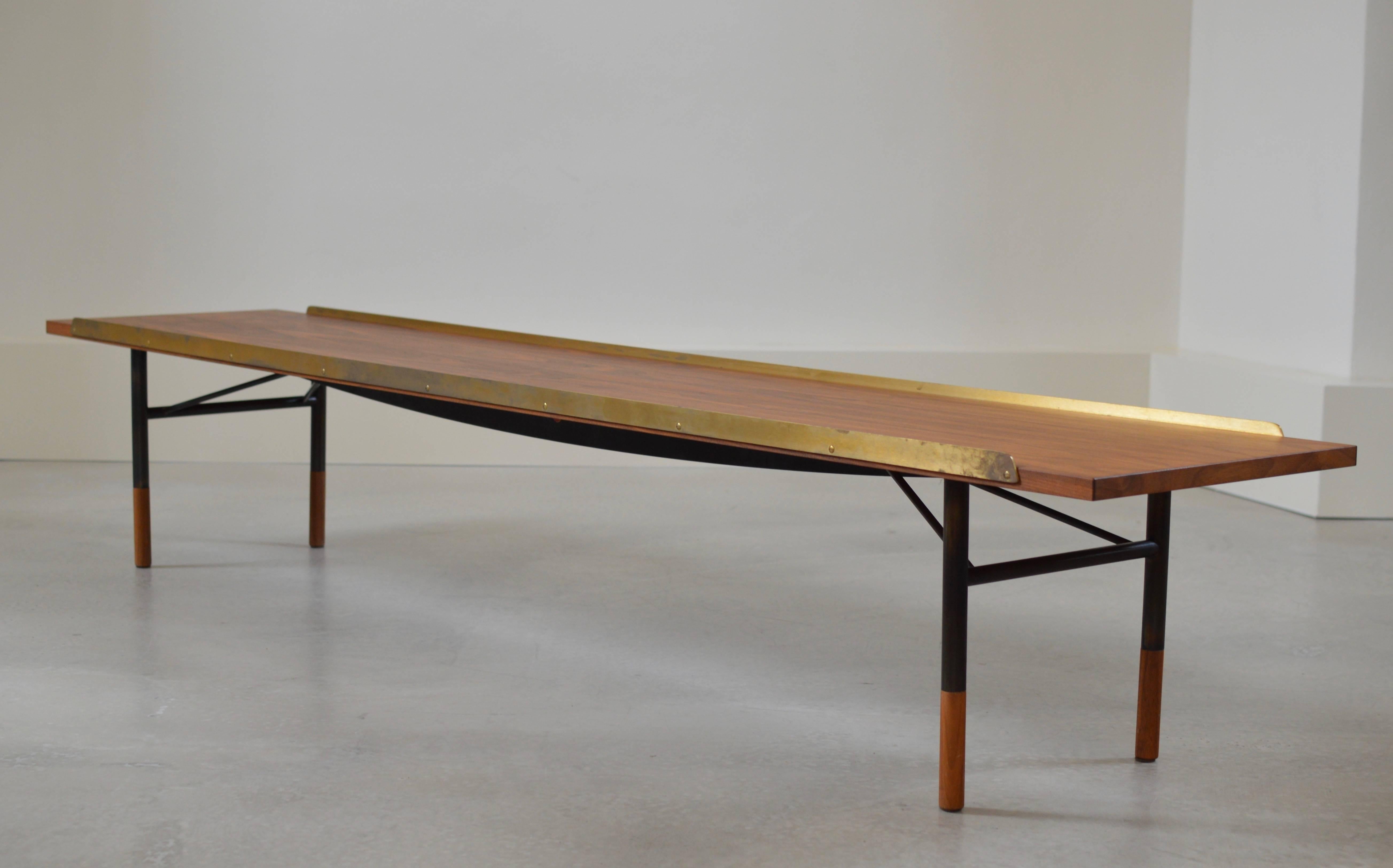 Bench in walnut and brass with burnished steel framework with wooden toes. Originally drawn in 1954 by Finn Juhl and executed by Bovirke. This bench is one of the very first benches manufactured in 2012 by sole license holder One Collection who then