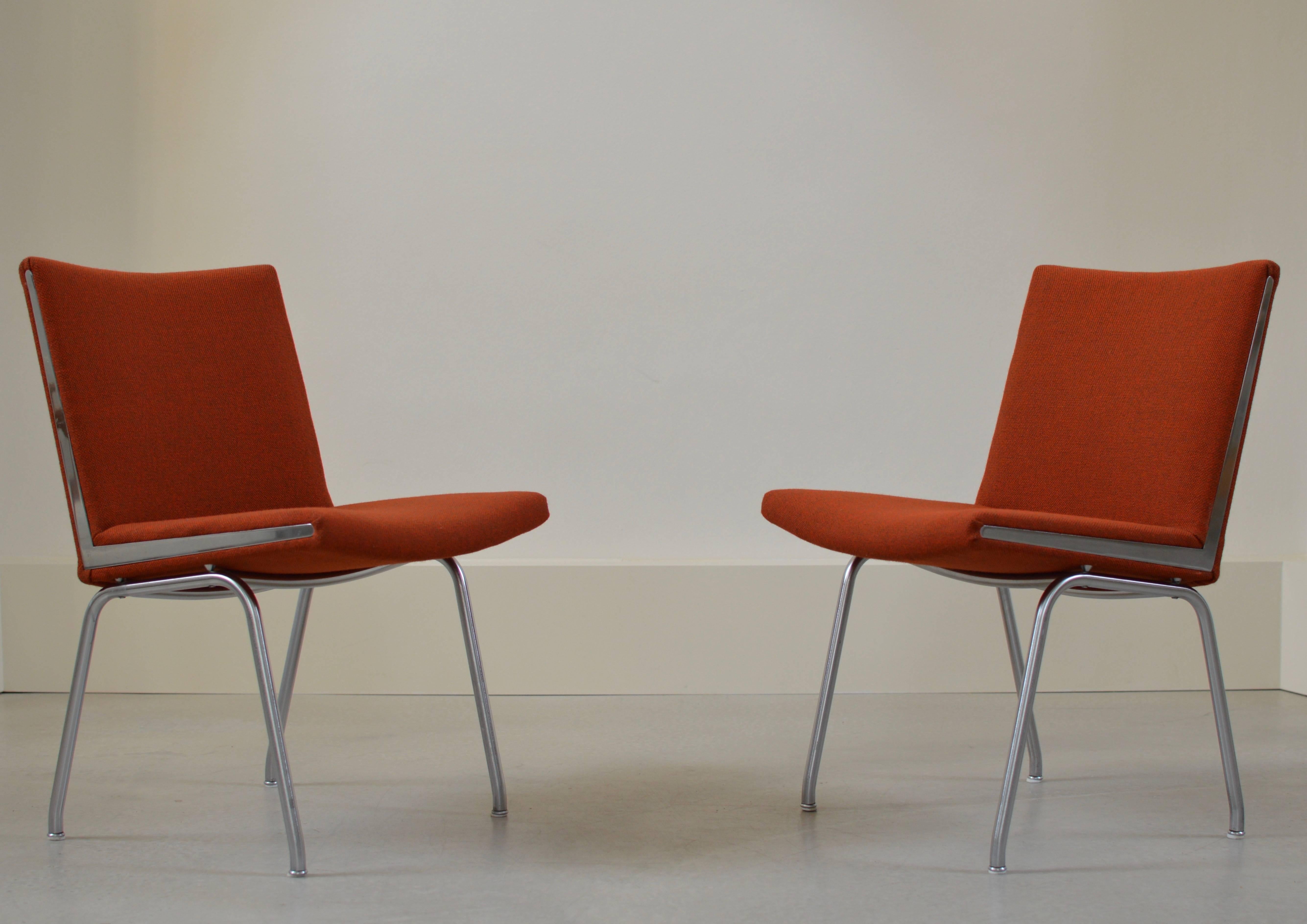 Wonderful pair Kastrup chairs by Hans Wegner, designed in 1958 for the Danish Kastrup (hence the name) Airport, executed by AP Stolen Denmark. 
Brushed steel legs with fully upholstered seat and back in Kvadrat fabric with beautiful sharp chromed