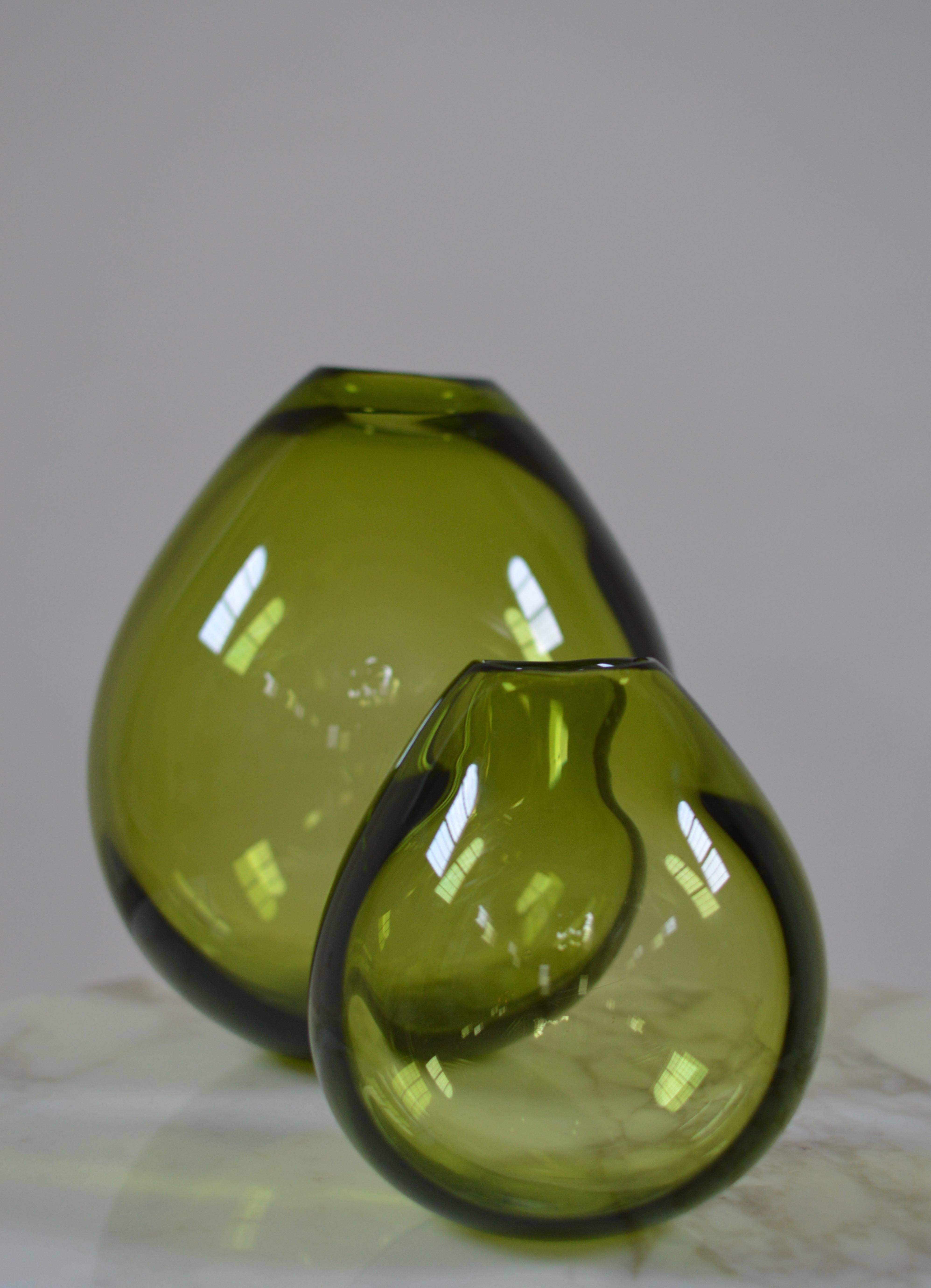 Iconic mouth blown 'Drop vases' by Danish glass designer Per Lutken for Holmegaard, 1960s. 
The distinctive and characteristic neck of each individual vase shows the uniqueness and value of true handicraft. 
These green colored vases are