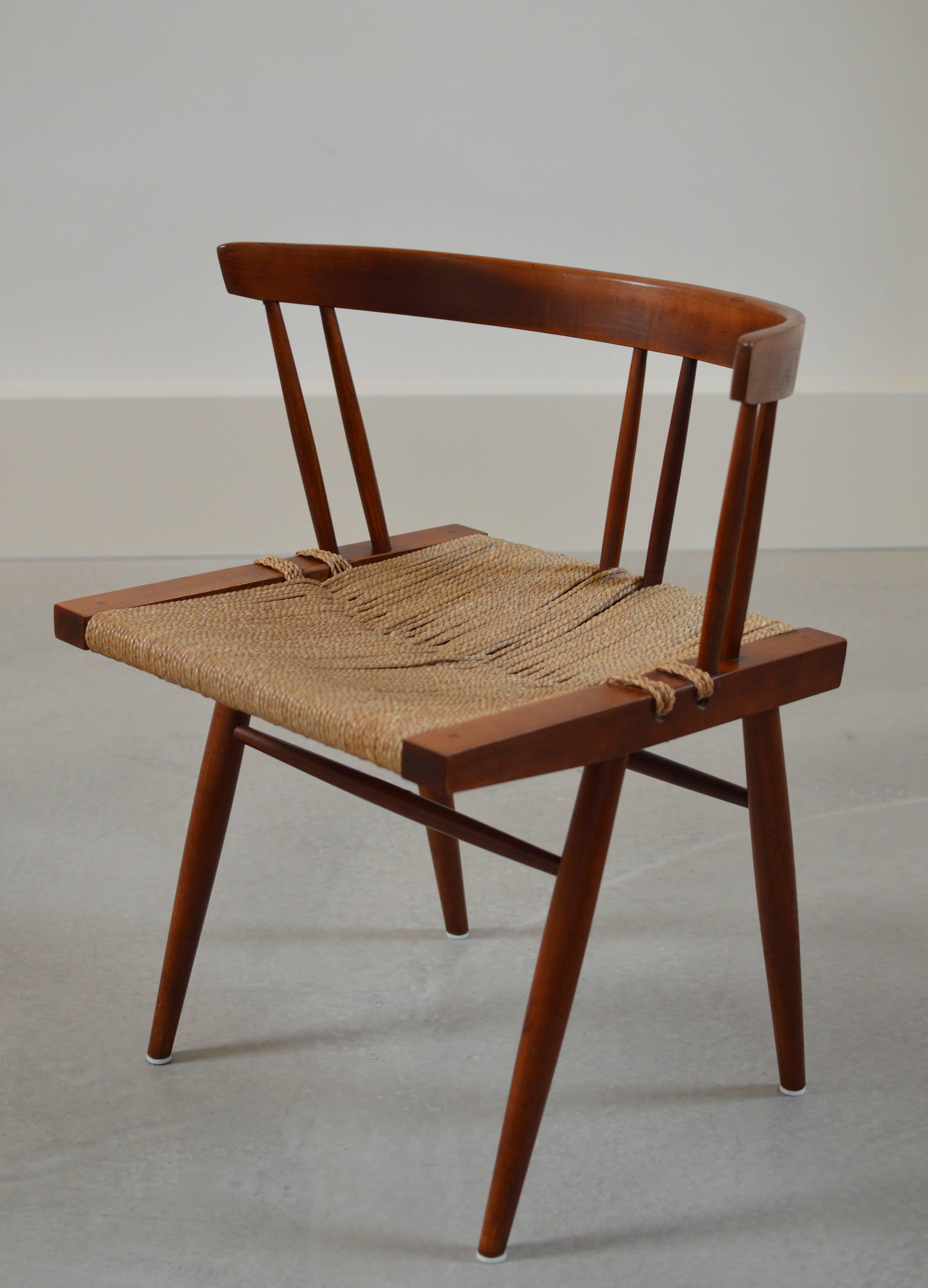 Single grass-seated chair from circa 1950s production in black walnut by George Nakashima, Nakashima Studios.