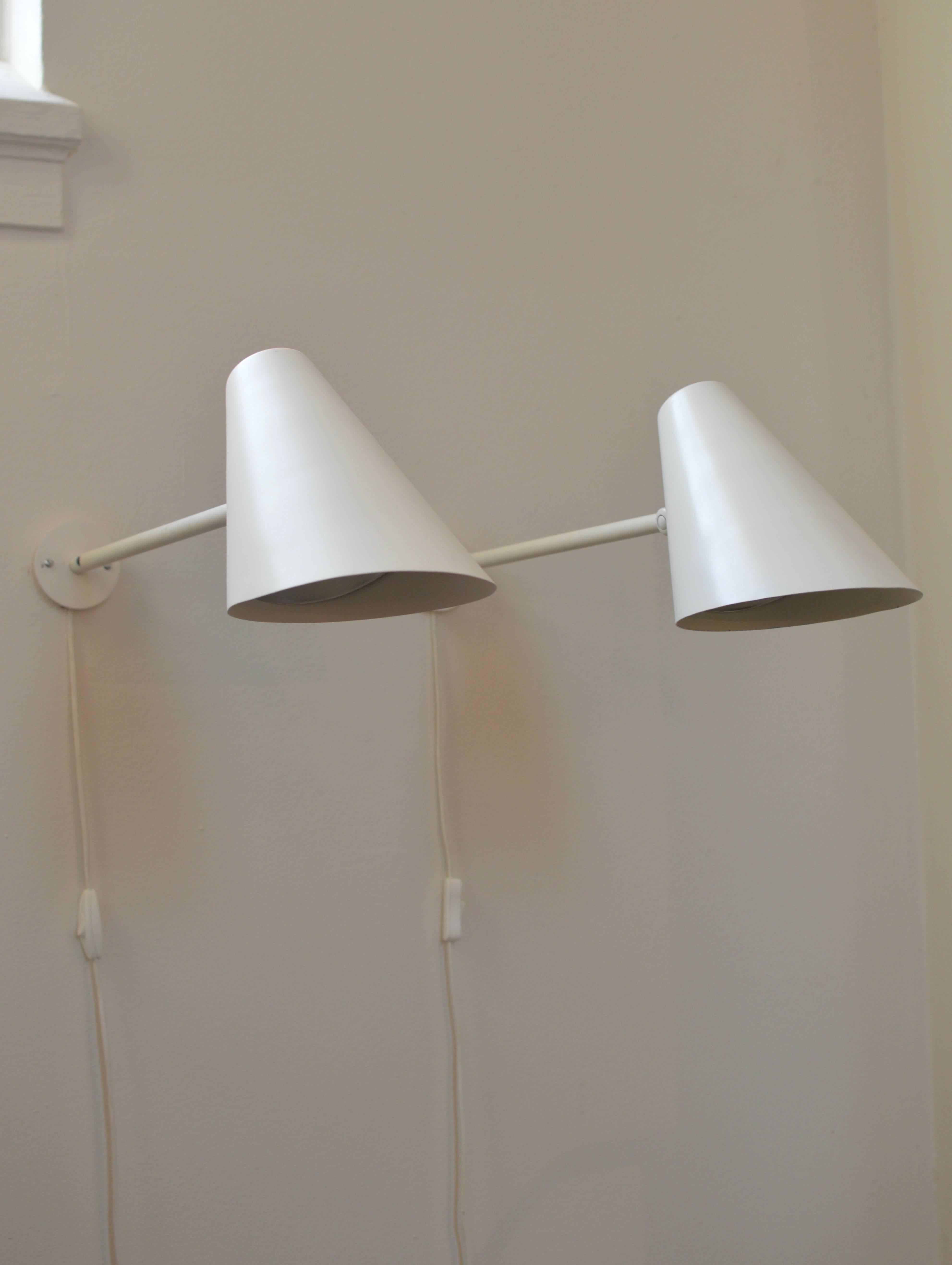 Rare large white wall lamps attributed to Vilhelm Lauritzen with interior reflector's executed by Louis Poulsen. 
The lamps are executed with a hinge mechanism providing to adjust the shades as desired in up or downwards position. Designed in the