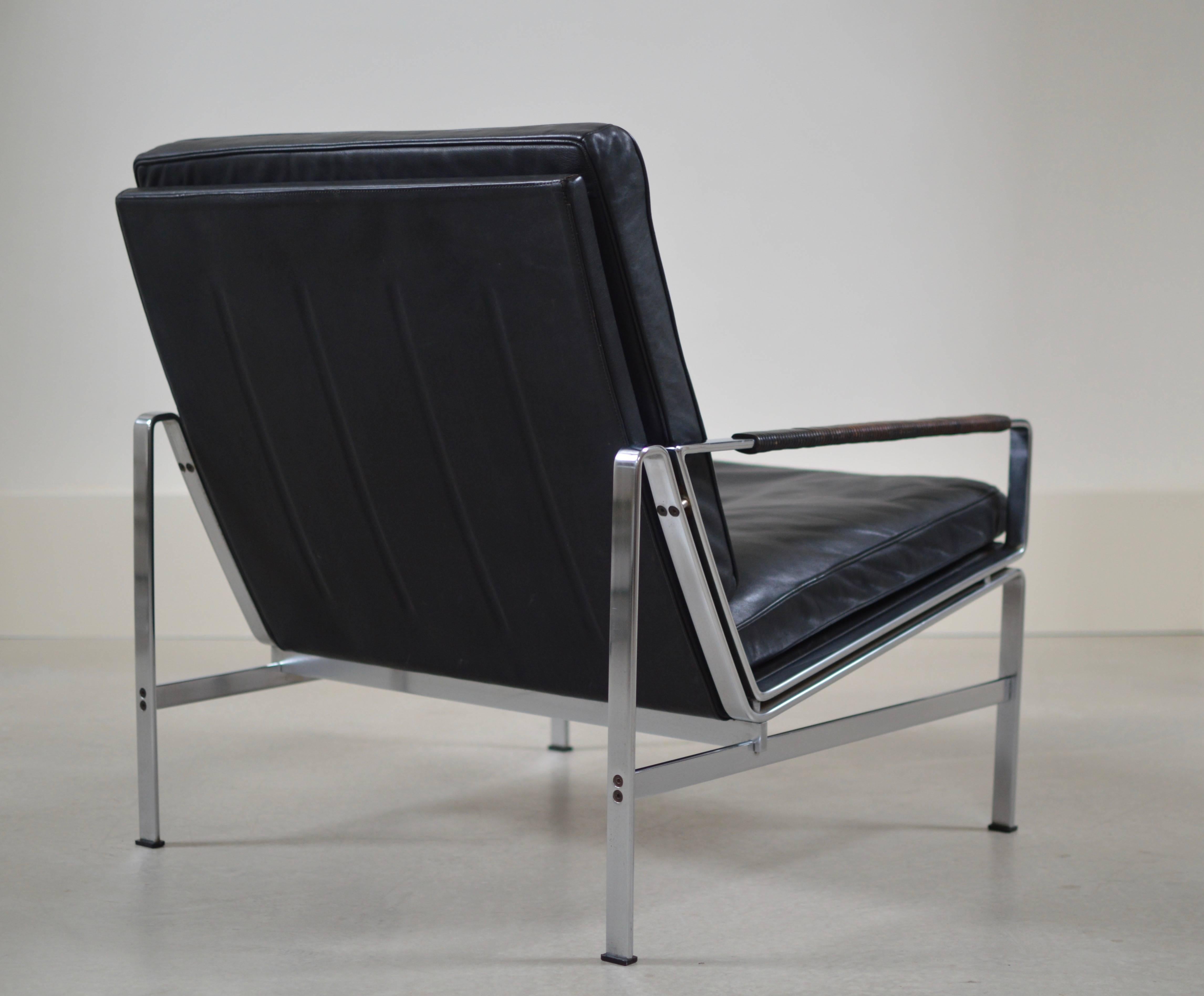 Armchair model 6720-1 by Preben Fabricius & Jørgen Kastholm by Alfred Kill. 
Upholstery is executed in 'yet black' leather with signature leather lace wrapped arm rest that turned wonderful patinated through out almost 50 years of gently use. The