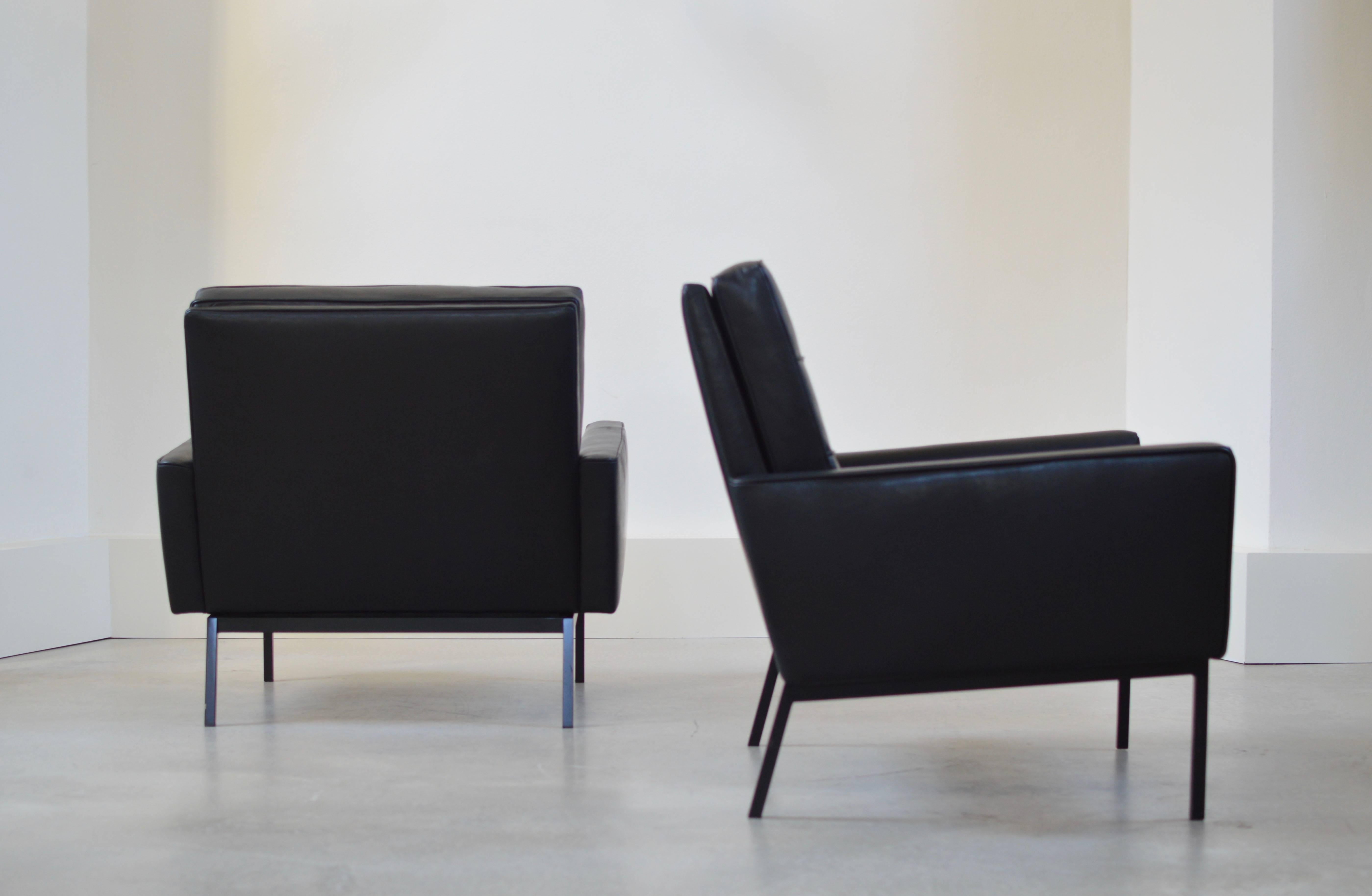 Pair of black leather Florence Knoll model 65A arm chairs with rare original black bases. Designed by Florence Knoll in 1958, discontinued in 1975. Seats are executed with inner springs which make these chairs highly comfortable. 
Chairs have been