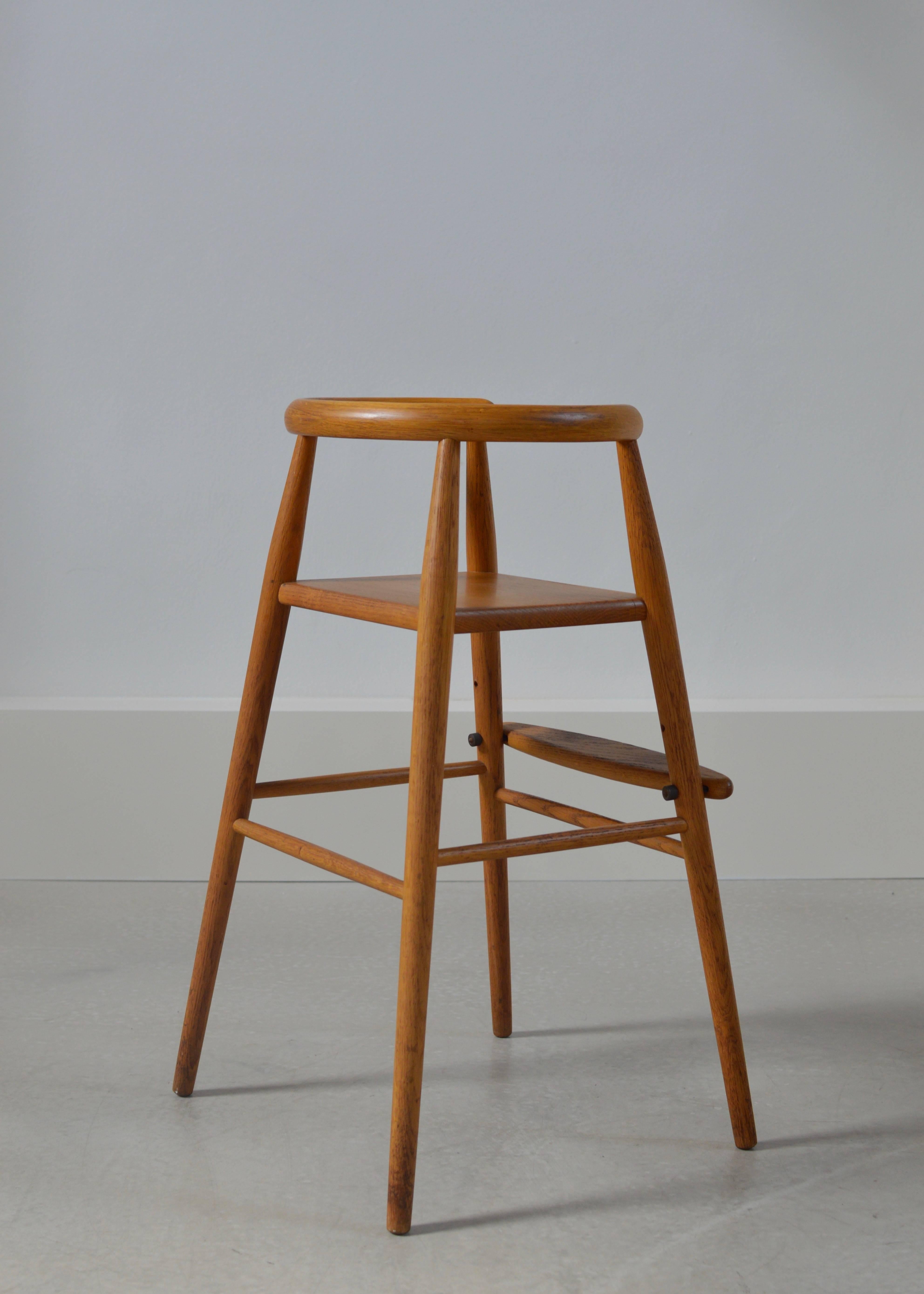 Solid oak children's high chair by Nanna Ditzel for Kolds Savvaerk, Denmark with adjustable foot rest in lovely gently used condition.