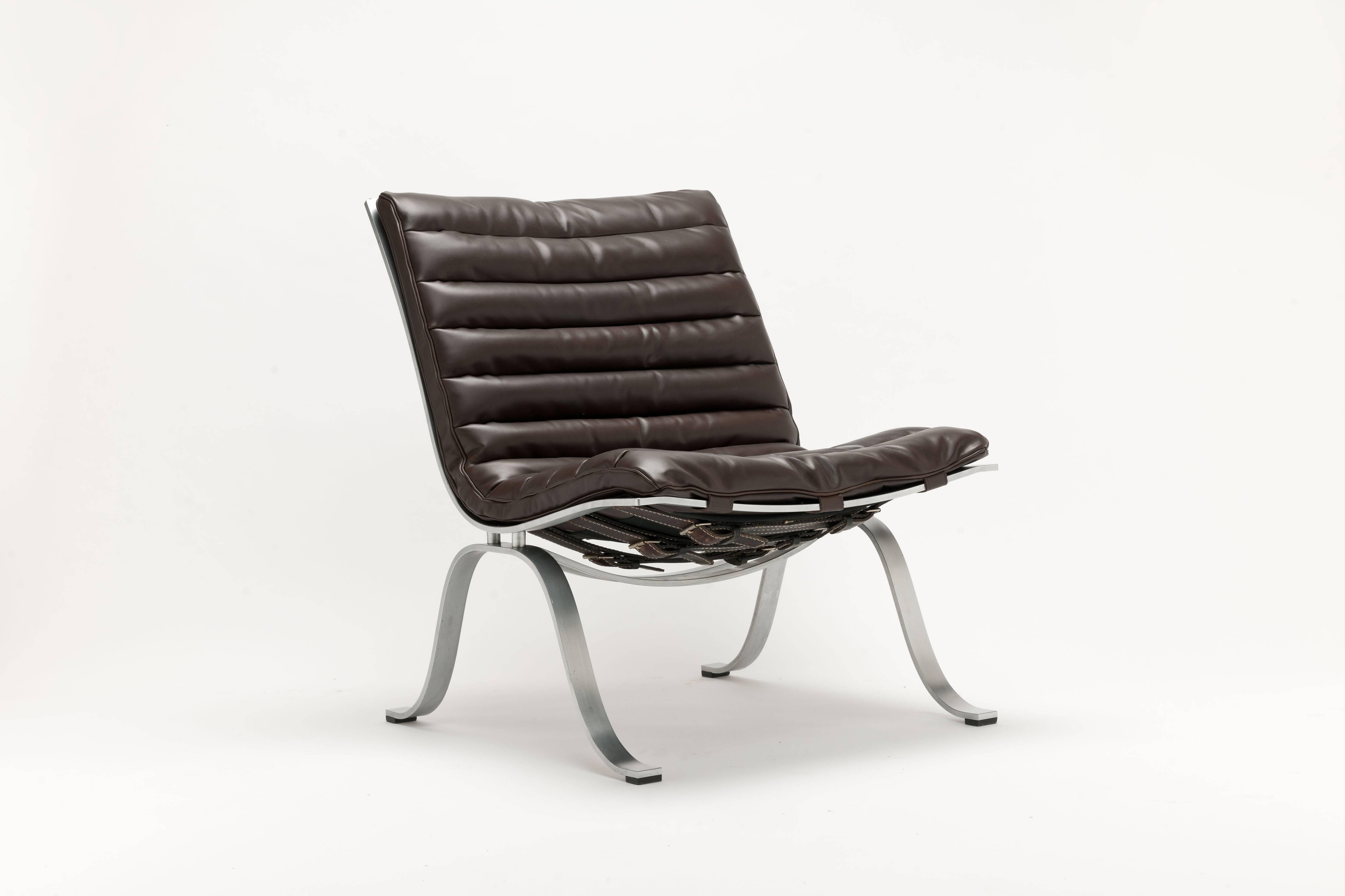 Dark brown leather Ariet Lounge chairs by Swedish designer Arne Norell, designed in 1968.  Manufactured by Norell Möbel, AB
These chairs date from the early 1970s and come with a matte chromed frame and their original vintage belts and buckles. A