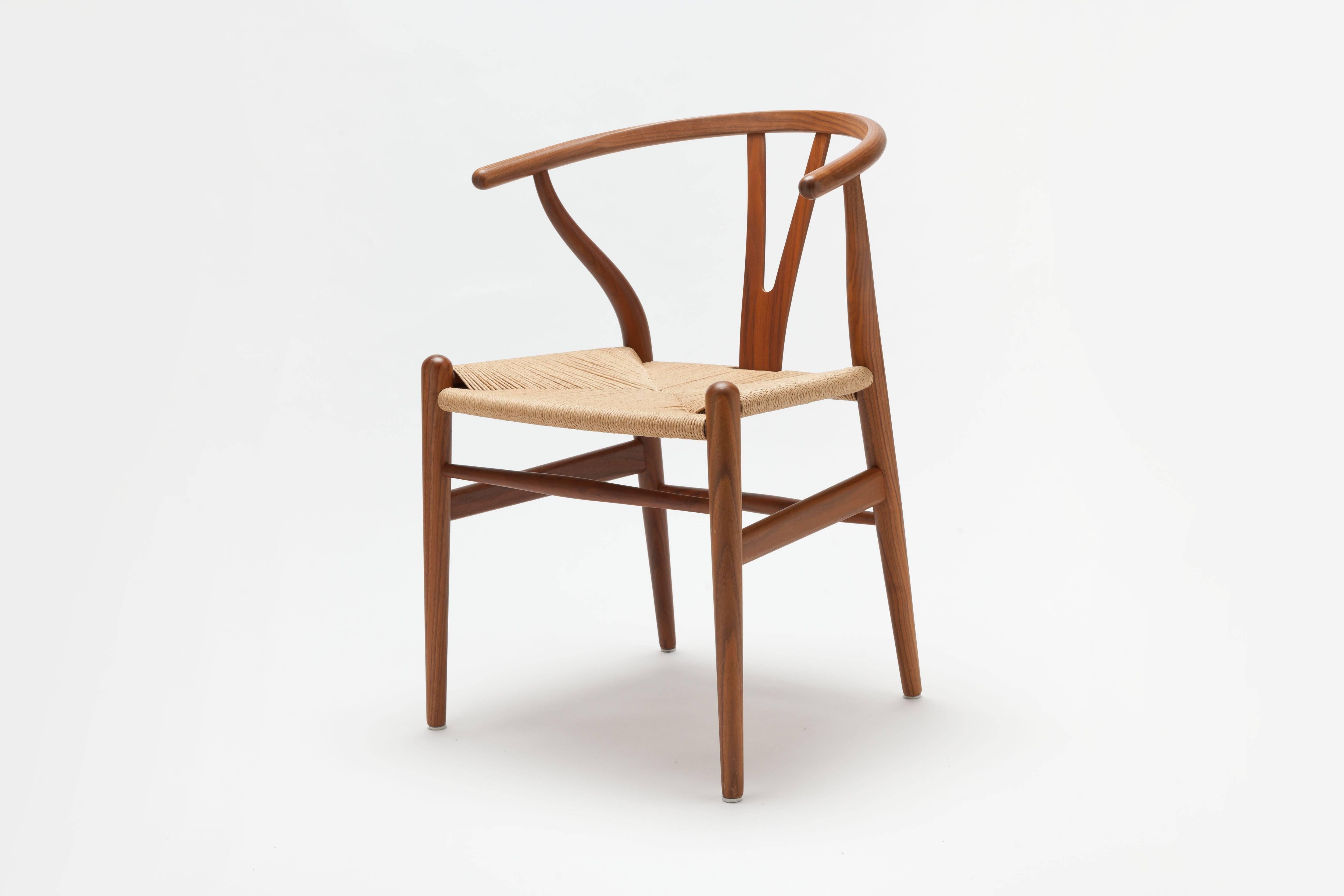 Single Wishbone / CH24 Chair executed in the most exclusive wood timber available, solid walnut, with handwoven natural paper cord. 

This single chair is an exhibit model in excellent as new condition from recent production that ships from stock.