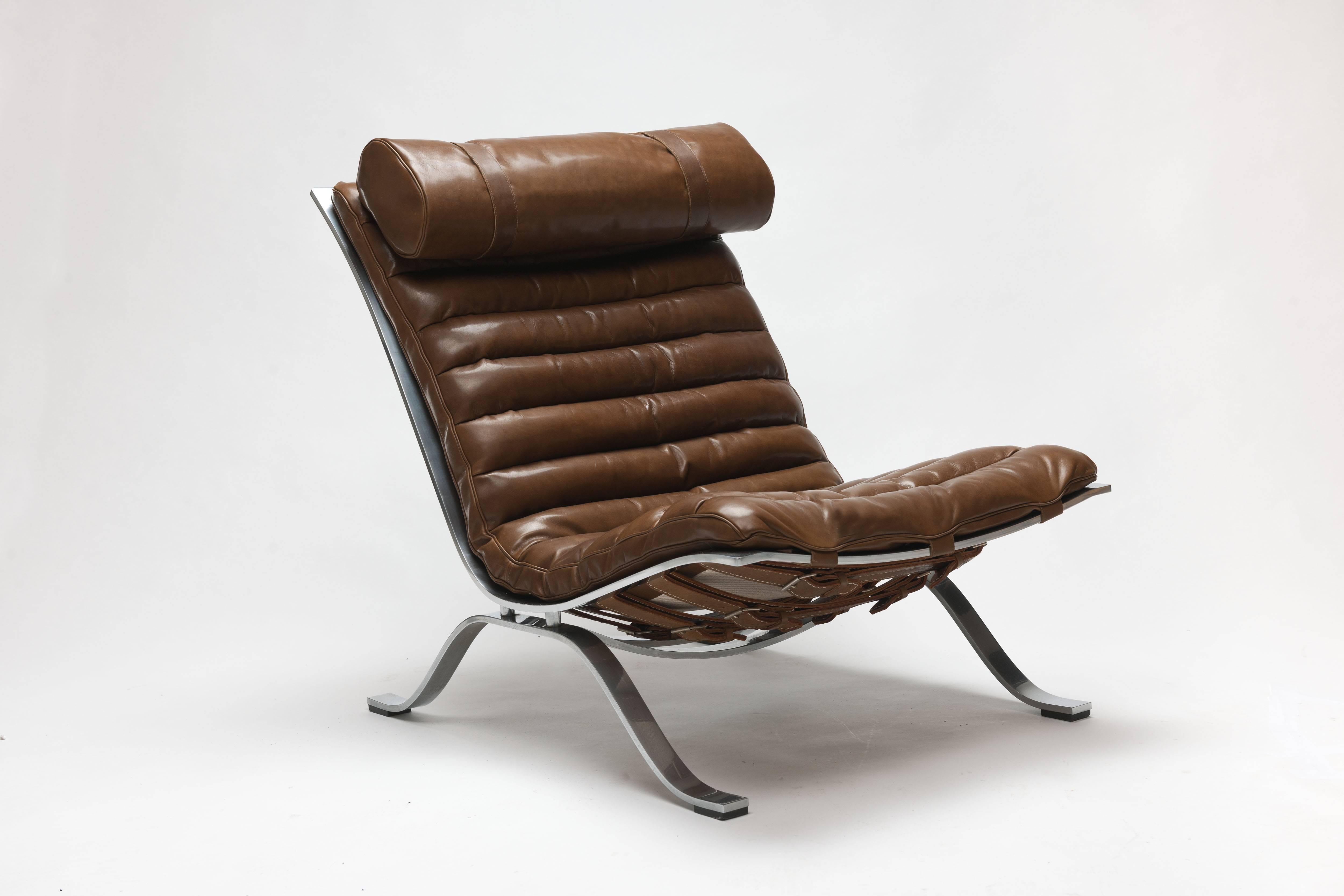 Low slung steel framed leather 'Ari' Lounge chair by Swedish designer Arne Norell, originally designed in 1966. 
This vintage lounge chair comes with new upholstery, executed in a refined bronze color leather, which is made by the original