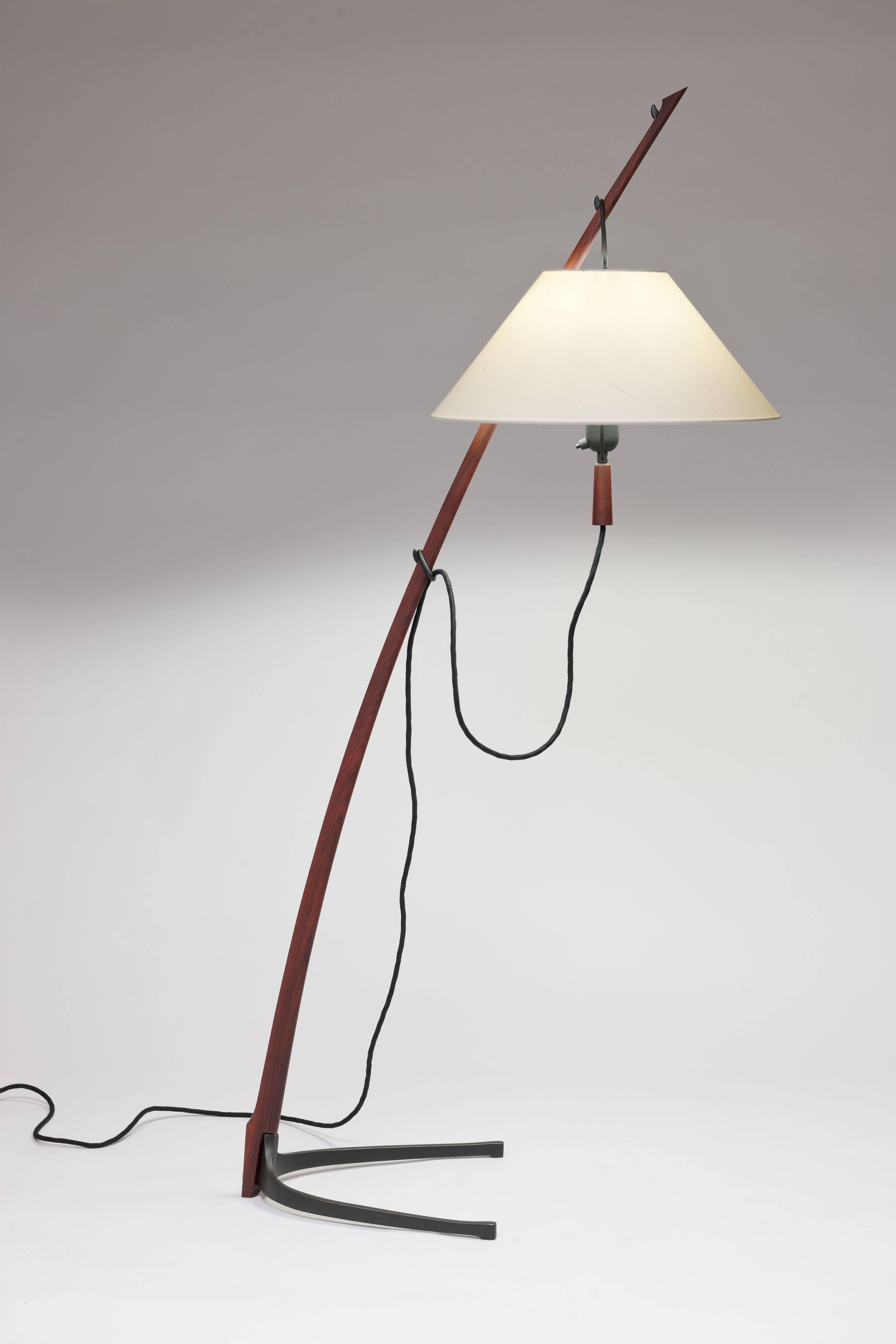 Contemporary re-edition of Kalmar's design from 1947. 
Rosewood saber-shaped stand with black brass fittings allowing the lamp shade to be positioned on brass hooks at three different, read-friendly height position. 
This is the most exclusive