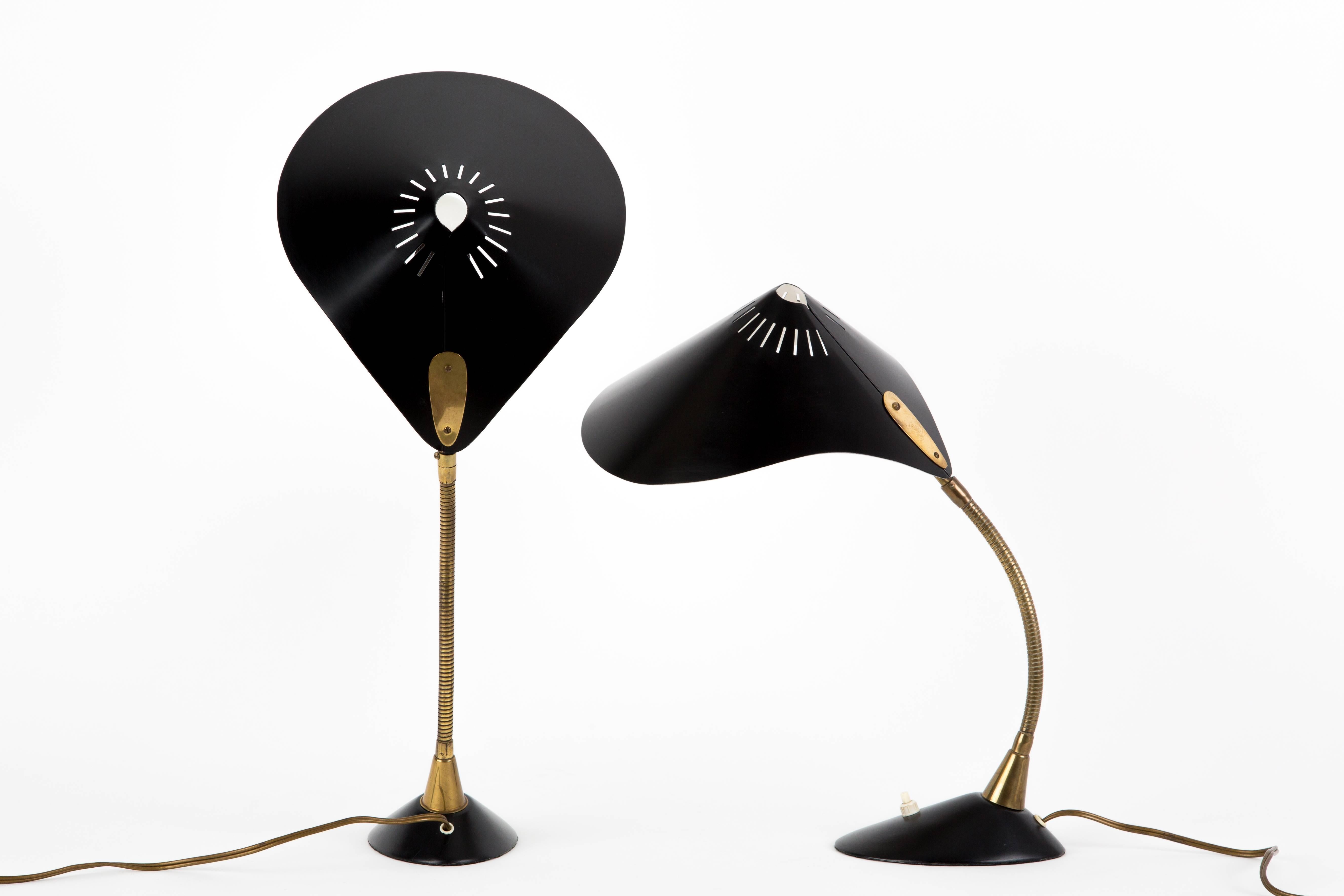 A pair of two brass COSACK TABLE LAMPS.  The standard can be deflected and is flexible. The base is very heavy for good stability. Thin black hat white inside.