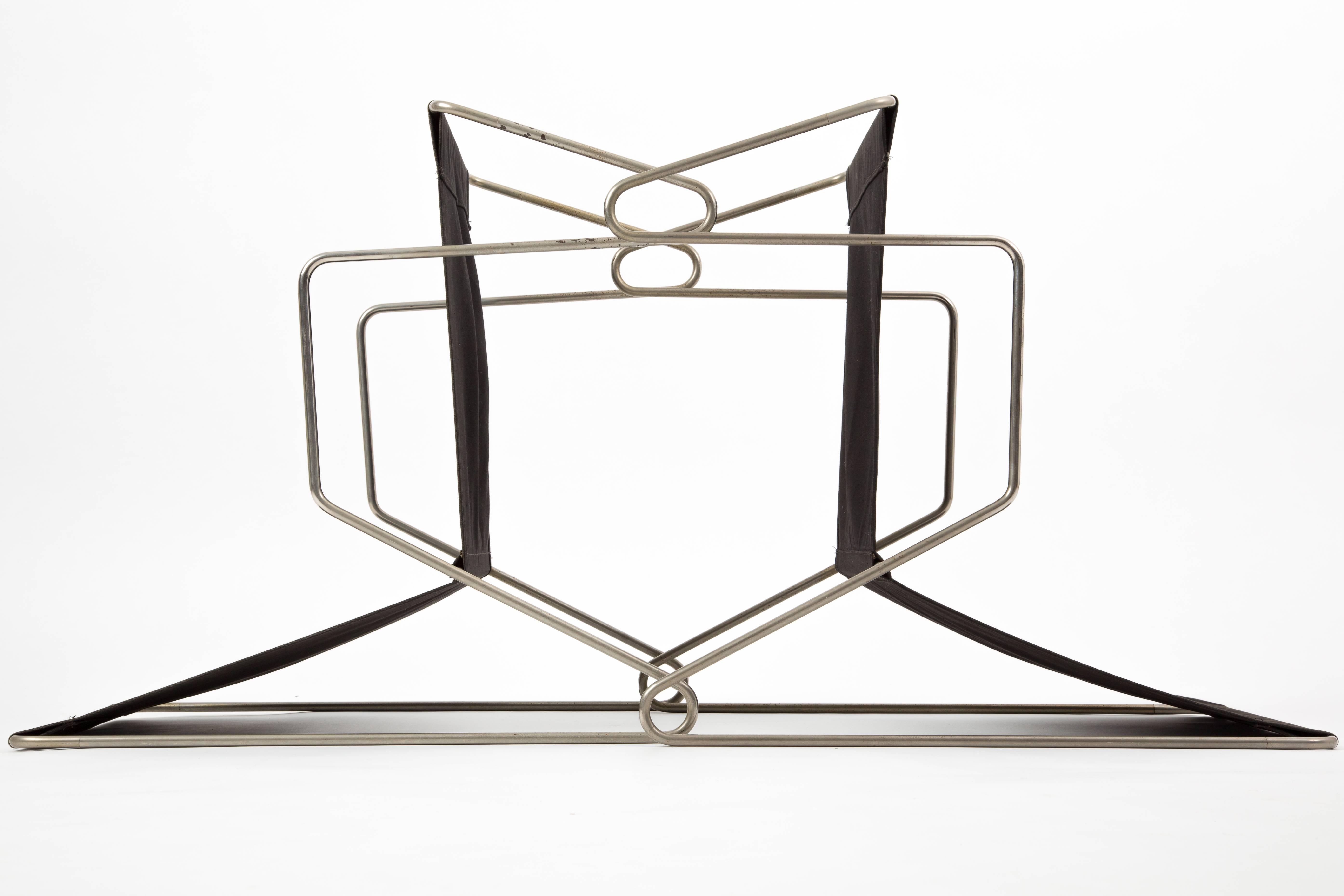 A pair of Bachelor chairs designed by Verner Panton for Fritz Hansen, at least 50 years old. The canvas is anthracite colored. The very thin frames are the topic of this design. The chairs are nearly a graphic thing.