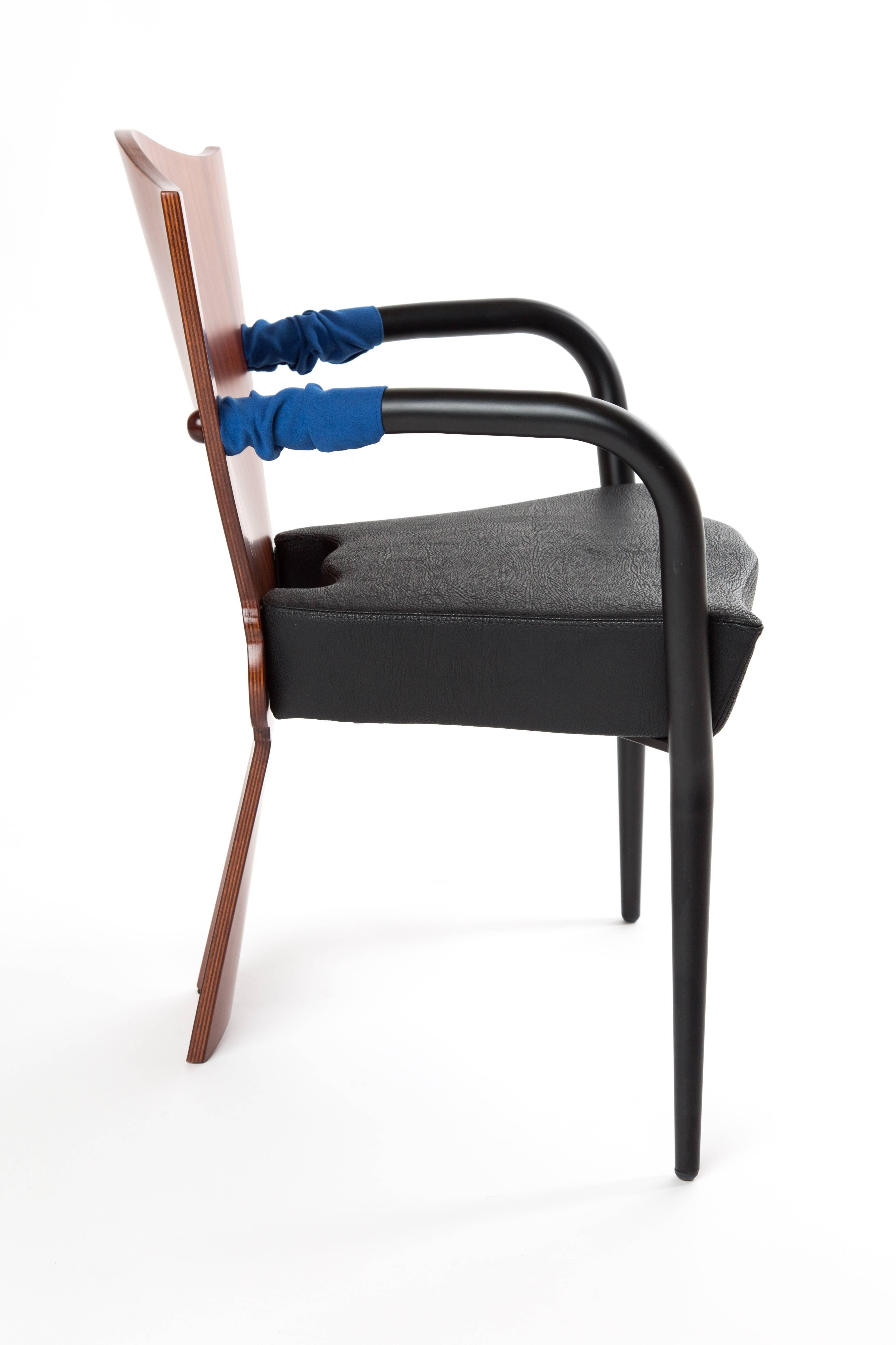 The Dalami chair designed Borek Sipek in 1994 for Scarabas. The chair is like a throne. He used different materials. Plywood for the back, cut in a classic form, looks like a tulip, metal legs with a soft blue part of fabric. The sitting is of raw