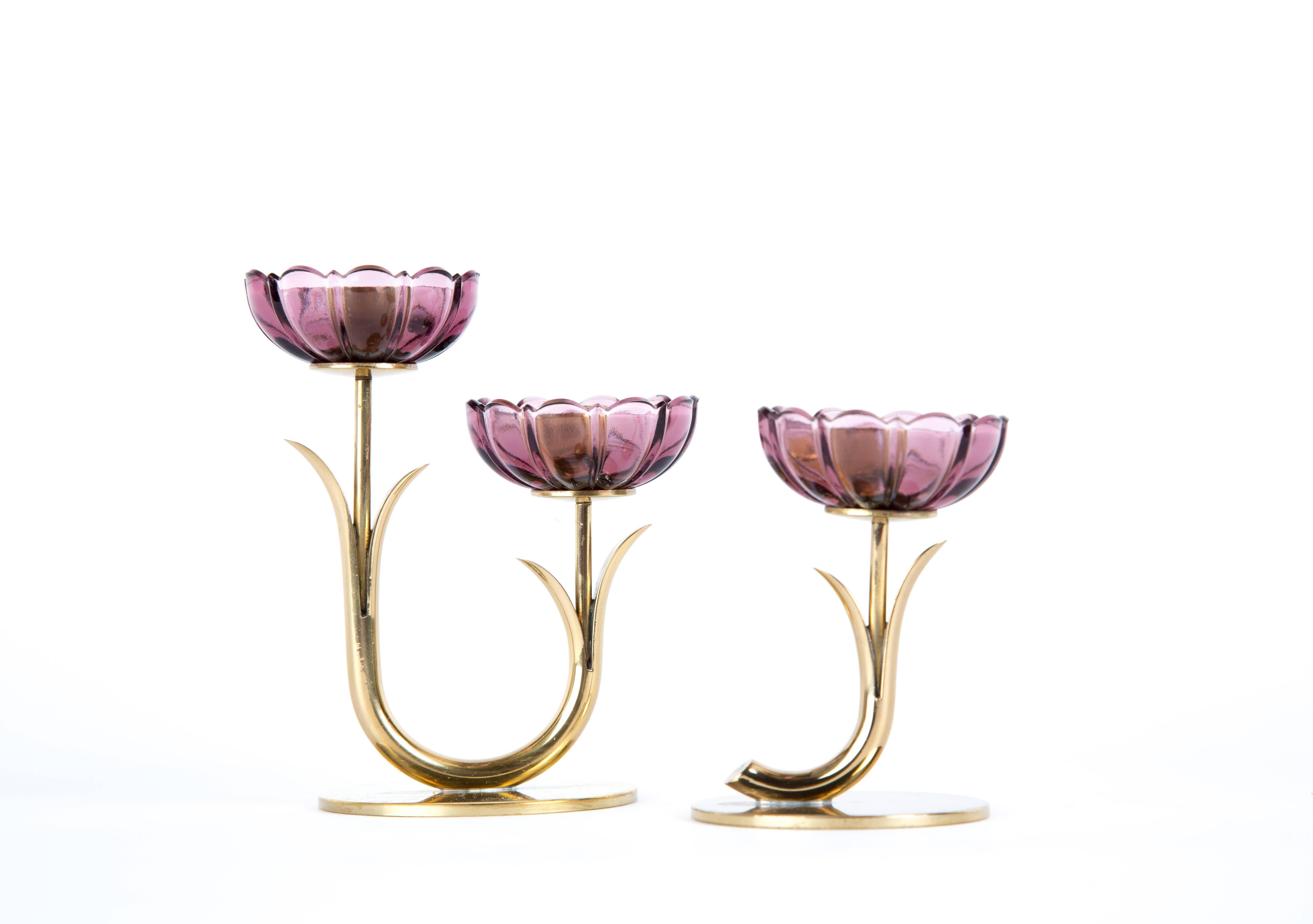 A set of two Gunnar Ander candleholders. Dark pink art-glass. A double and a single candleholder. Signed on the bottom.