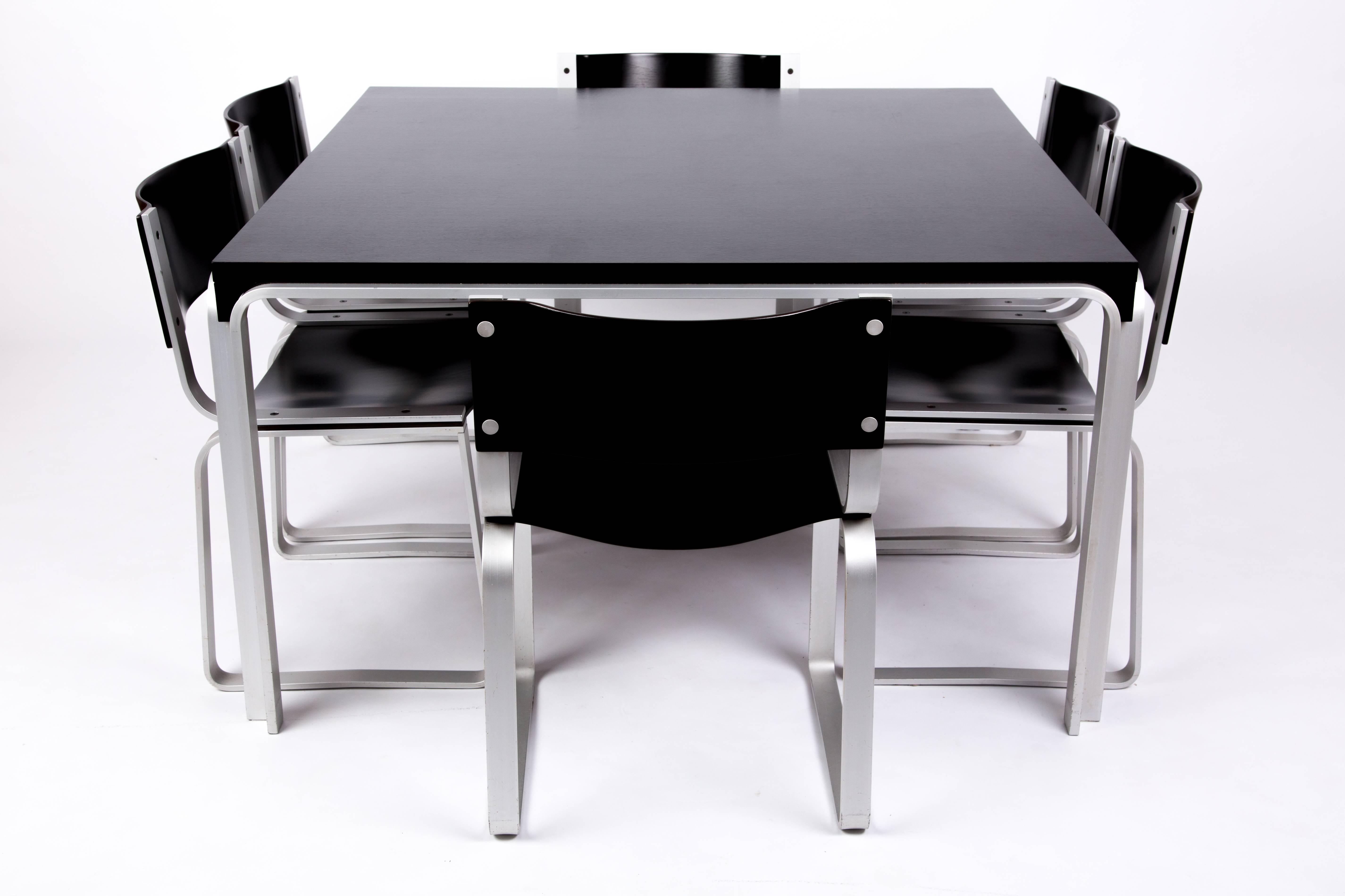 A set of six black plywood chairs with an anode-coated aluminum frame of flat metal. The set has been produced for a short time in 1972. The designer is Pierre Mazairac for Pastoe. The set has a futuristic character.
The size of the table is 129 cm