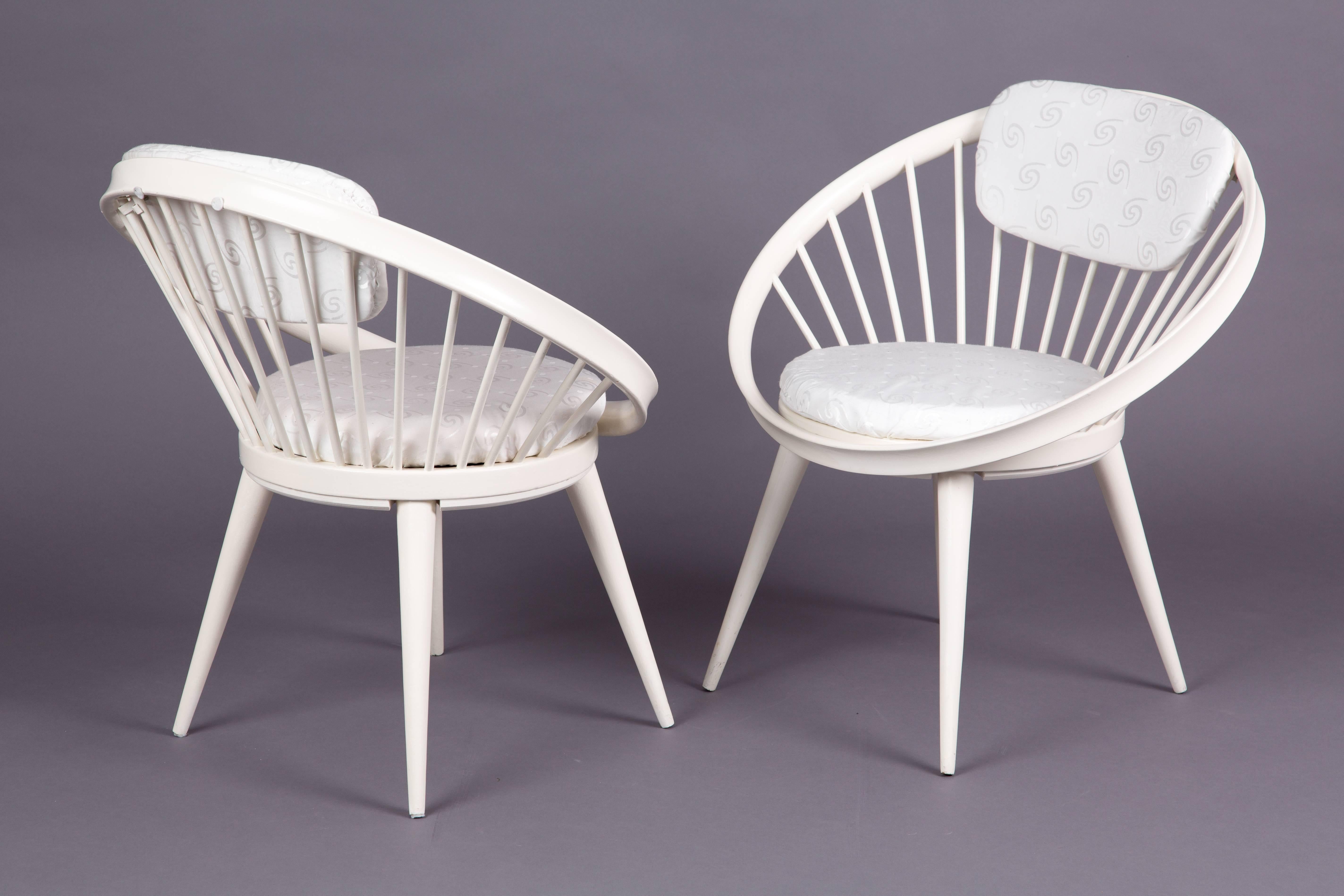 A set of two wooden circle chairs of Yngve Ekström. One chair has the original mark.