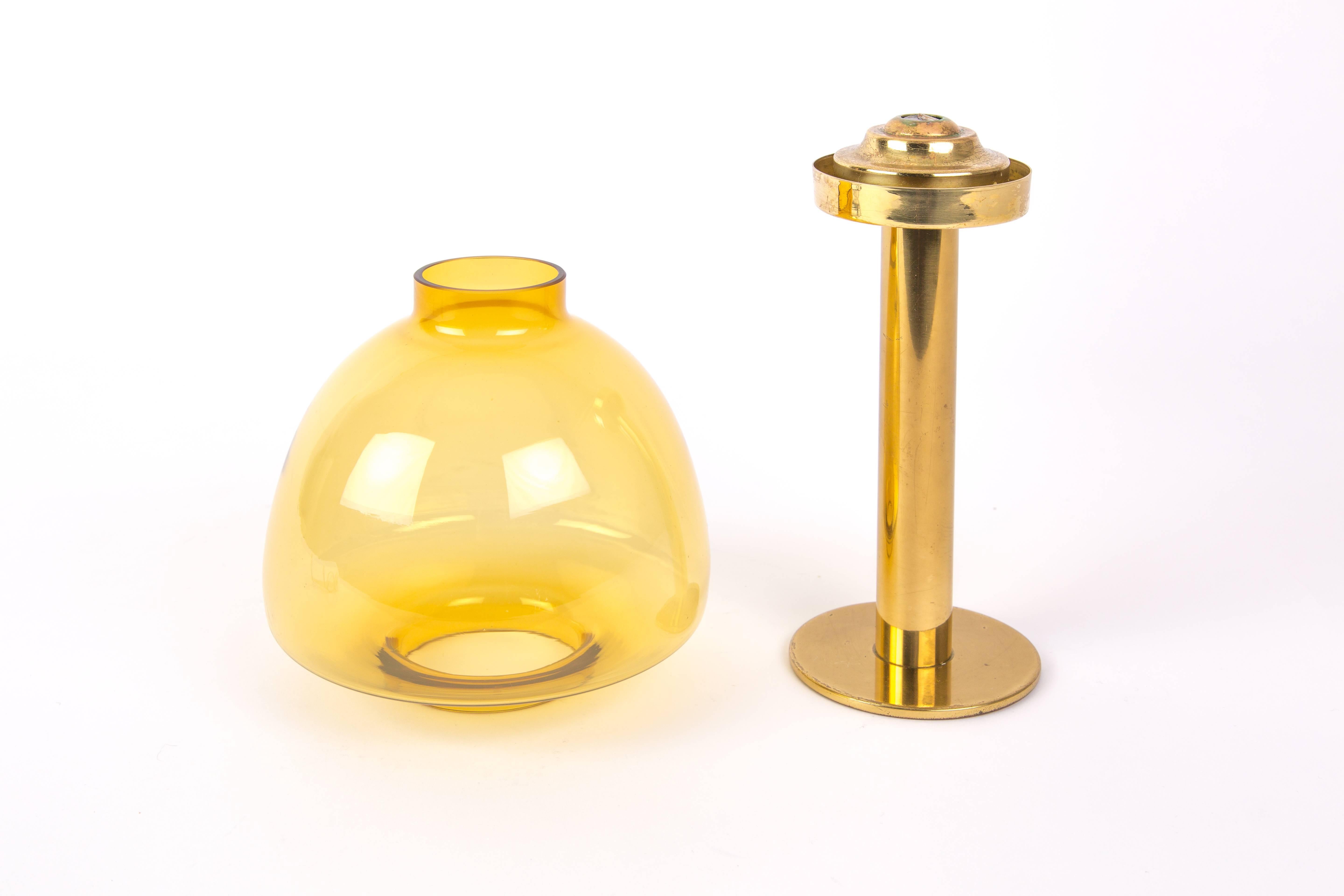 Hans Agne Jakobsson. Brass candleholder of Hans-Agne Jakobsson for Markaryd, Sweden. Gold-yellow glass. System with a spring for the candle.
Measures: Diameter base is 10cm, diameter glass bulb is 17cm and the height is 34.5cm.