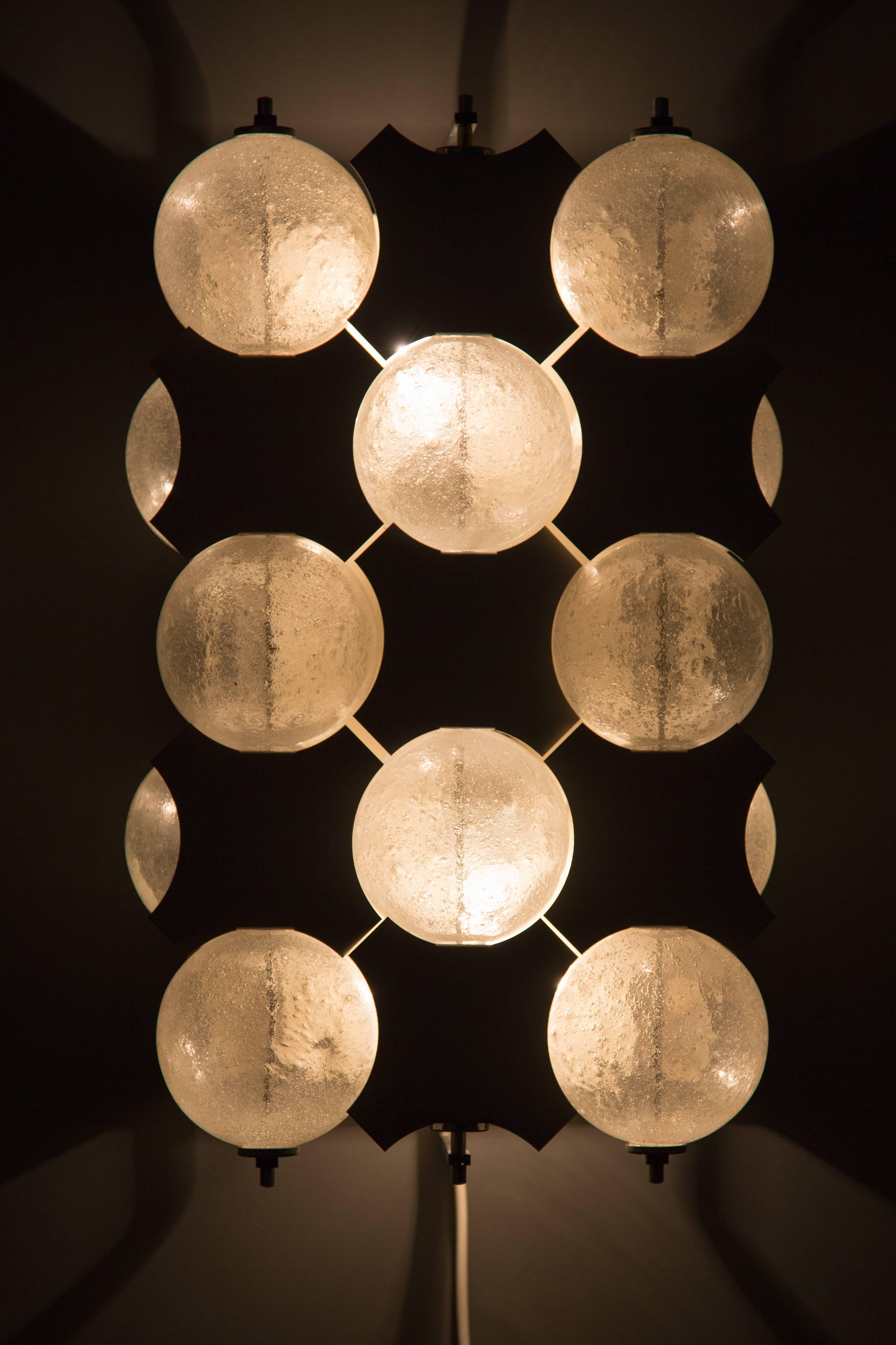 RAAK AMSTERDAM. Fiësta model 1645. Wall lamp of Dutch company Raak Amsterdam. The lamp has glass balls and aluminium reflectors. The aluminium parts can be moved to create a different effect at the light. The bulbs are behind the glass balls. 