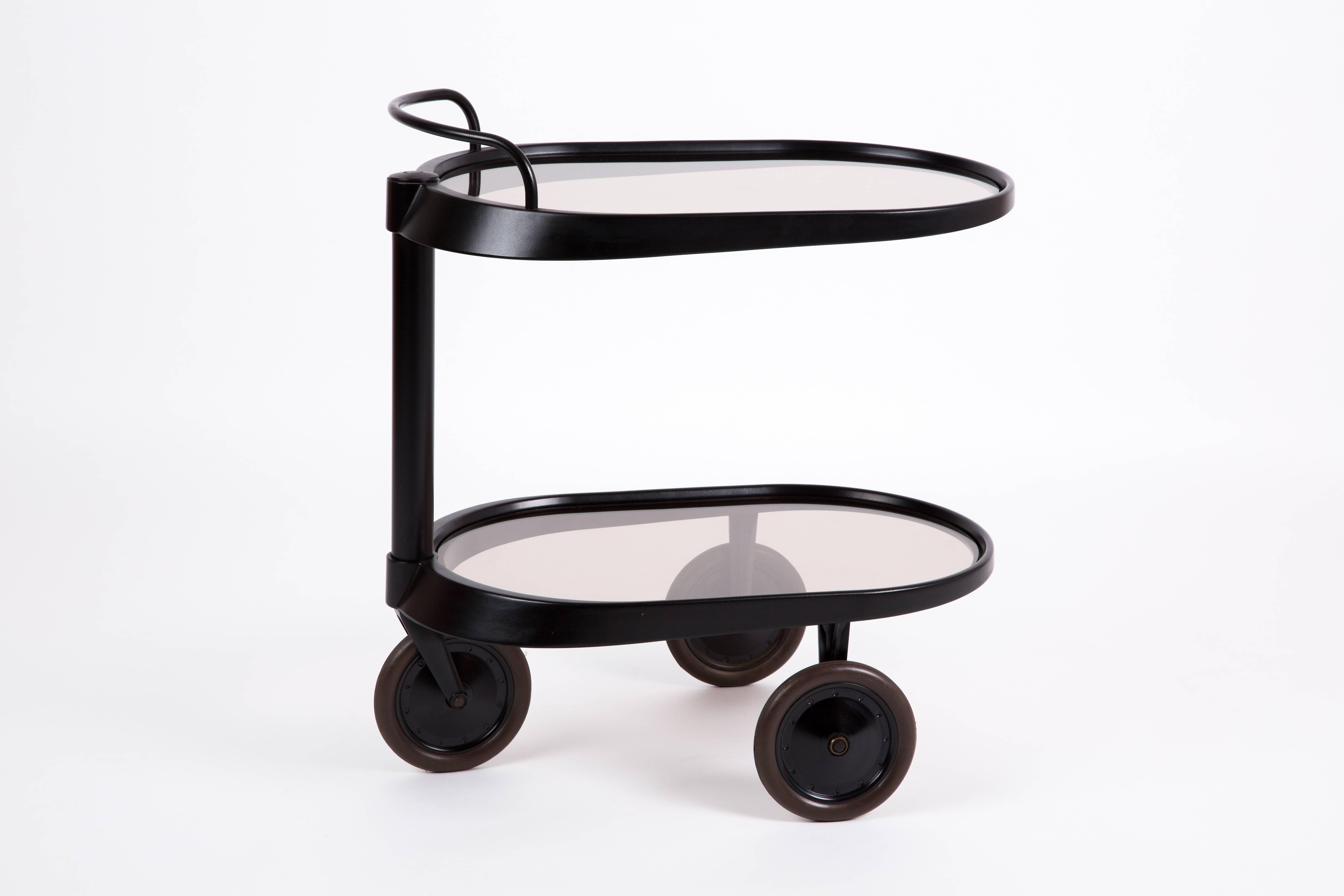 Theaserver by Enzo Mari for Alessi, with two smoked glass trays. The server has smooth-running wheels, with thick rubber bands. The server has been labeled with Alessi on top. Not in production yet.