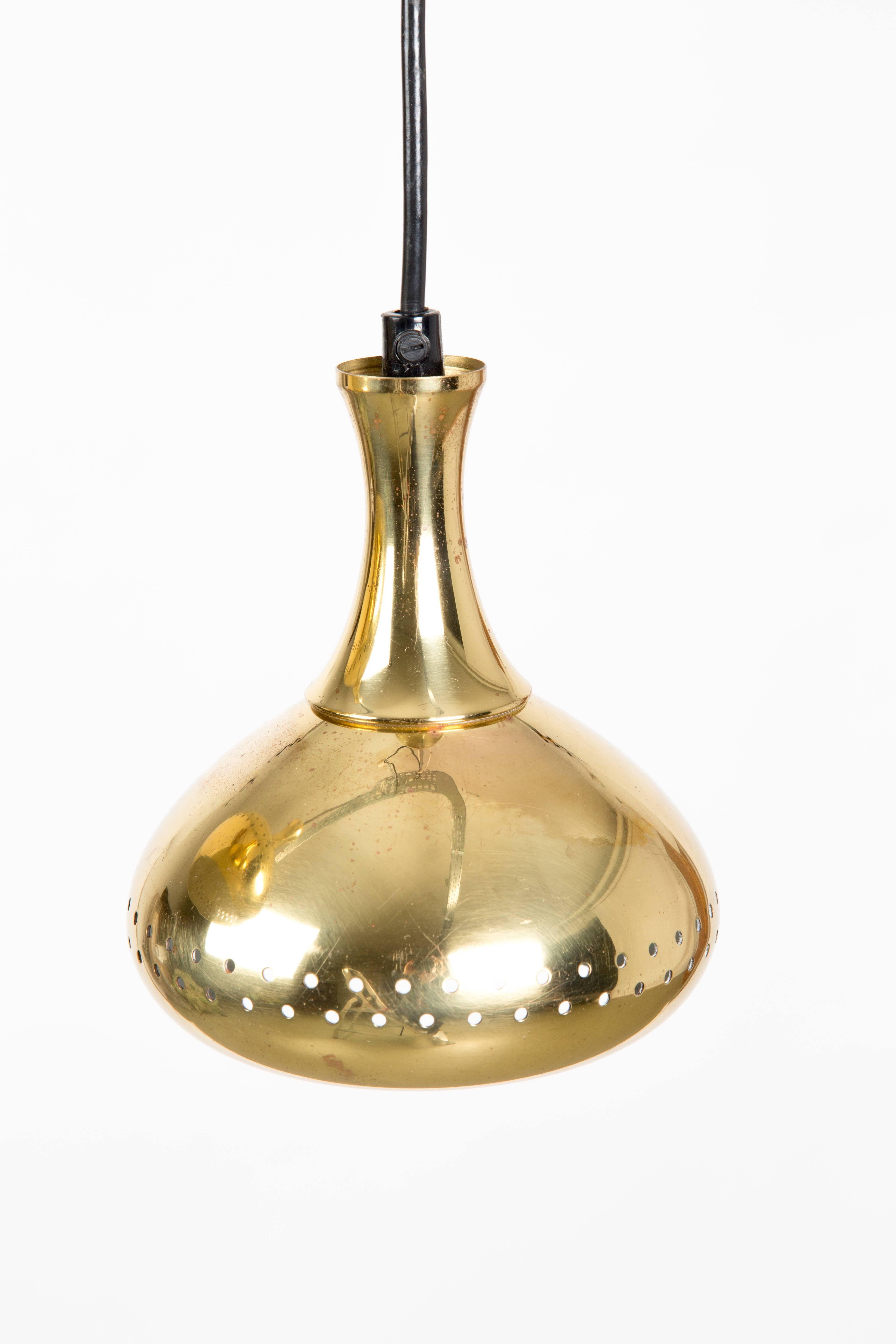 Pair of SWEDISH BRASS HANGLAMPS. The lamps are of brass outside and inside white painted. The small holes gives a diffused and romantic light. Designed by Hans-Agne Jakobsson.