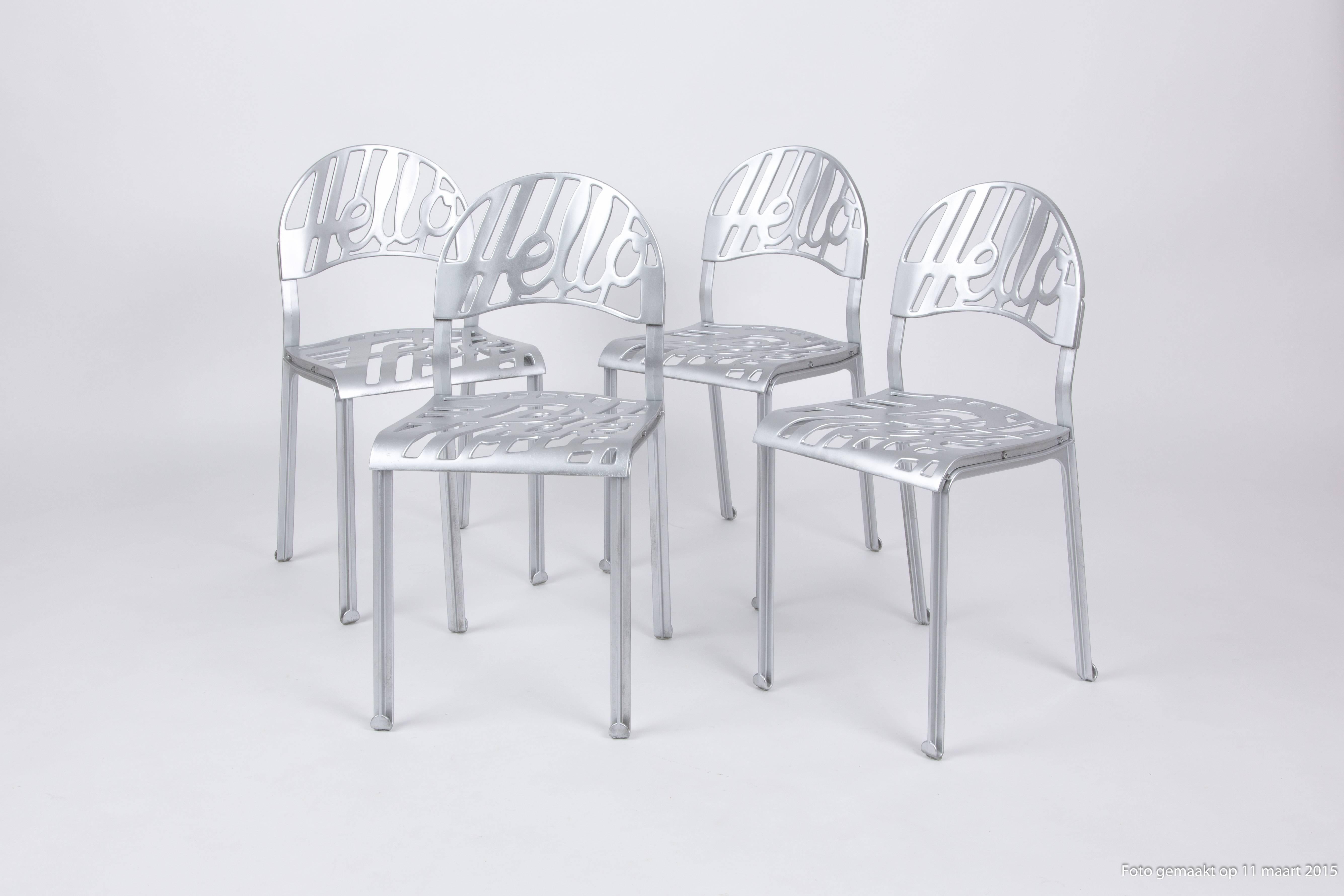 A set of six Jeremey Harvey aluminium chairs. The chairs are made of cast aluminium and coated. They also can be used outside. The chairs makes you happy with the text 