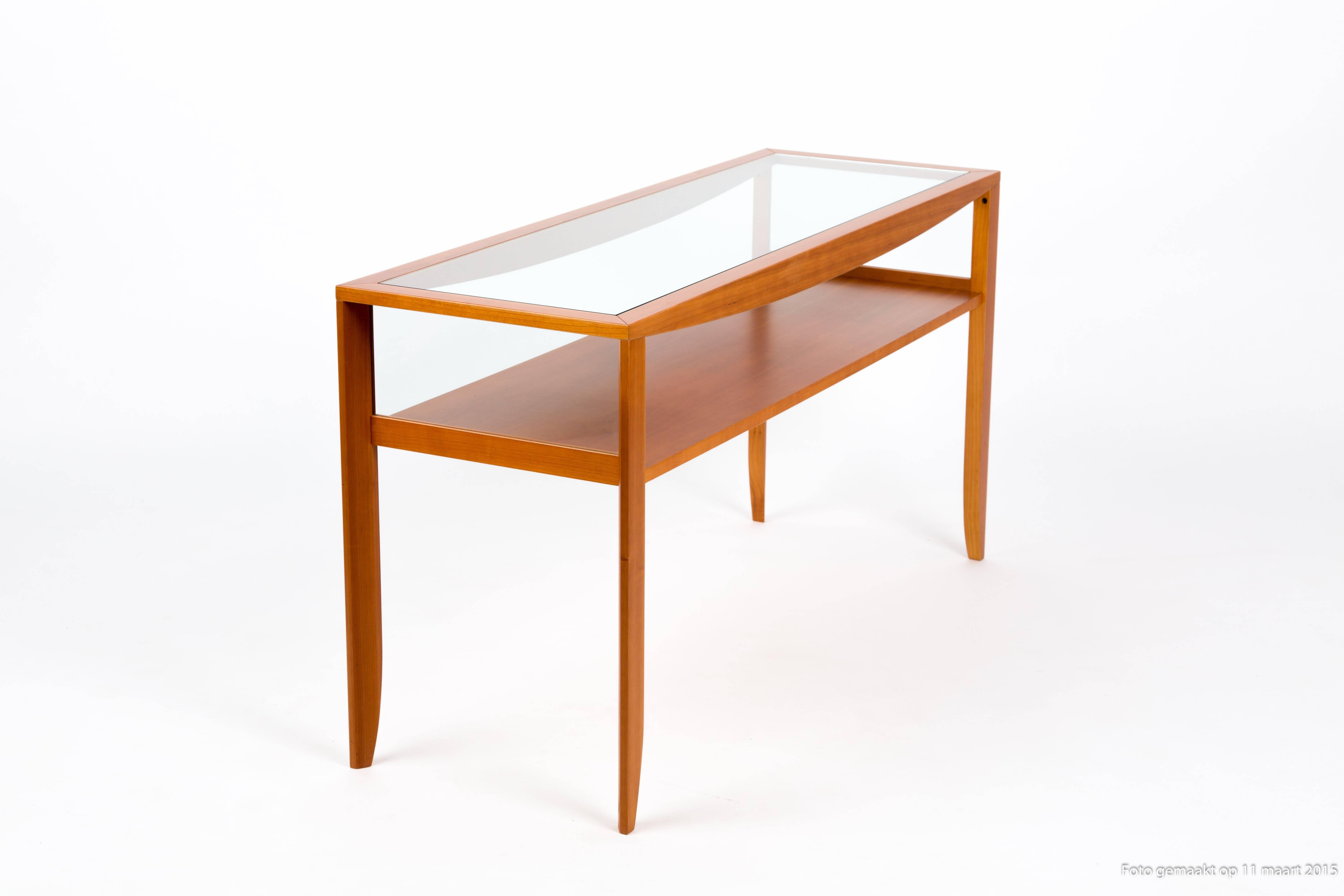 ITALIAN CATALAN SIDEBOARD. The cherrywood legs and top have an organic shape. The top is of glass. You can use it in the middle of some chairs, or as a real sideboard. The form is very minimalistic.