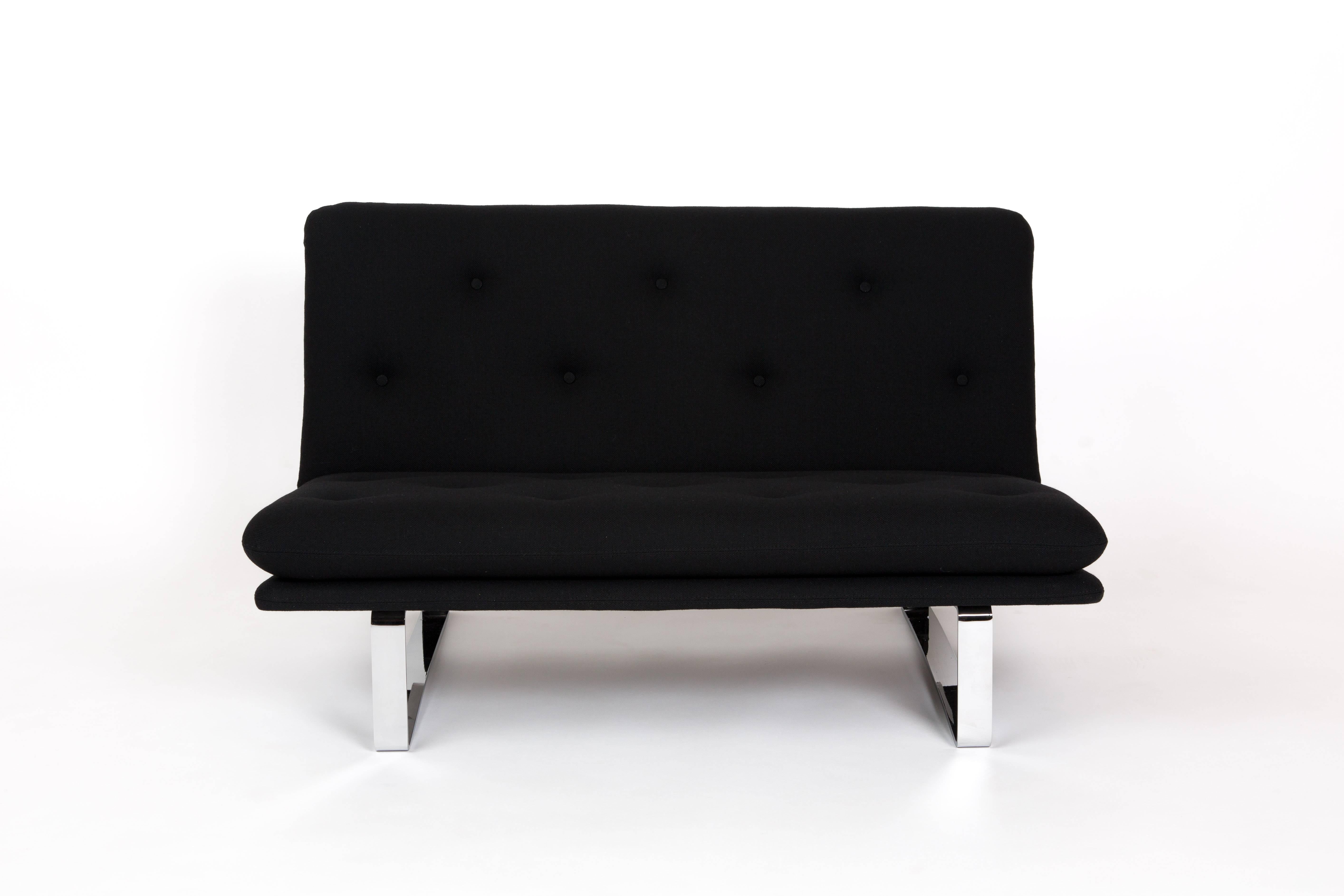 ARTIFORT LOVESEAT. Dutch sofa, designed by Kho Liang Ie for Artifort. This small love-seat is a two sitter. Not in productionn yet. Reupholstered with a black fabric. The cushion has been padded with black buttons. The legs are chrome-plated.

The