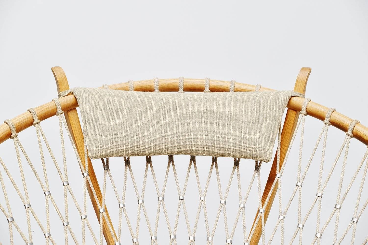 Sophisticated circle lounge chair model PP-130 designed by Hans J. Wegner for PP Mobler, Denmark 1986. This chair is made of solid oak, superbly crafted and finished with rope connected with metal clips. The upholstery is still the original and the